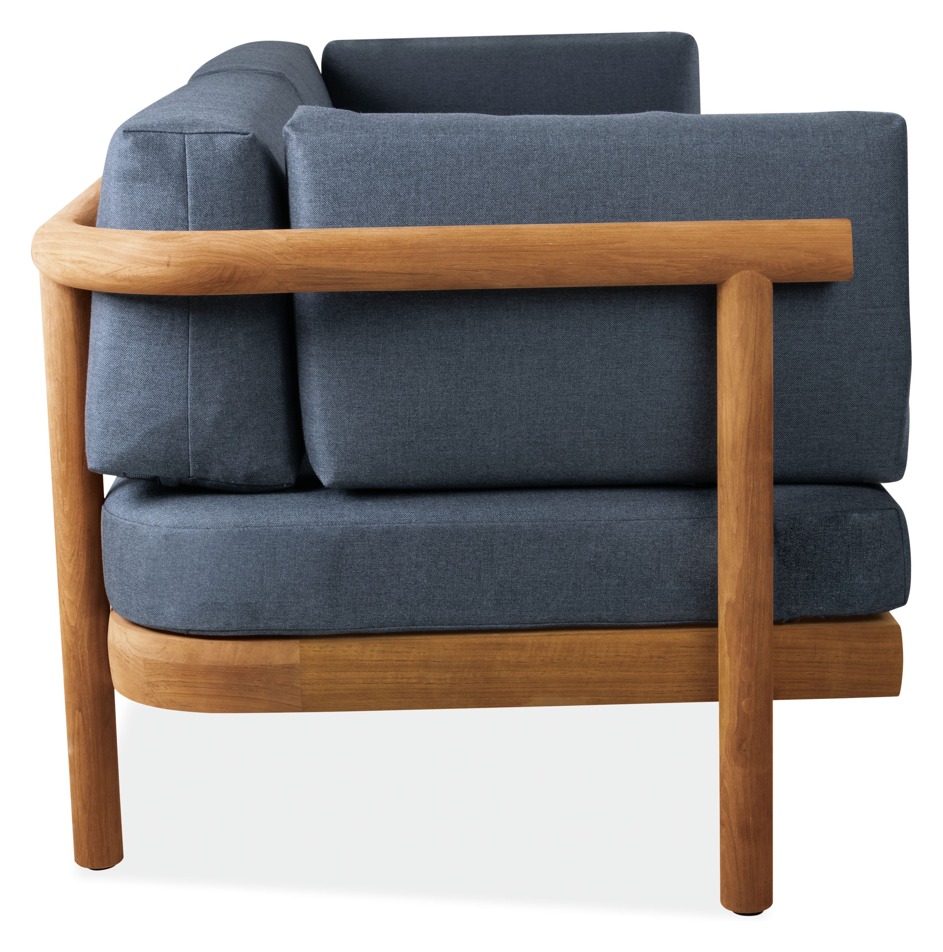 Side view of Isley 87-inch Sofa in Teak with Cushions in Bolton Navy.