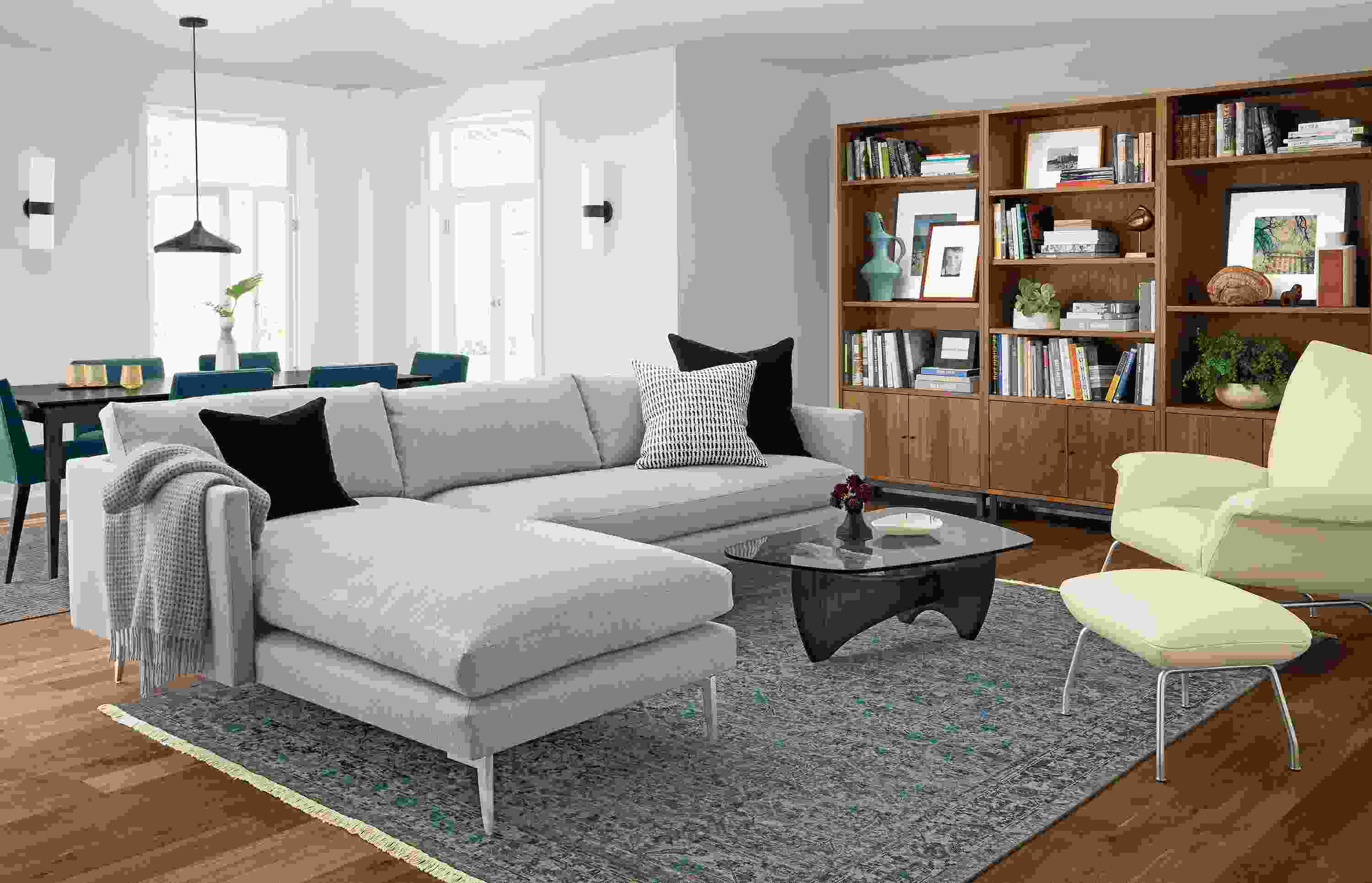 Janus 111-sofa with left-arm chaise in Hines Grey and 3 Copenhagen bookcases in walnut.