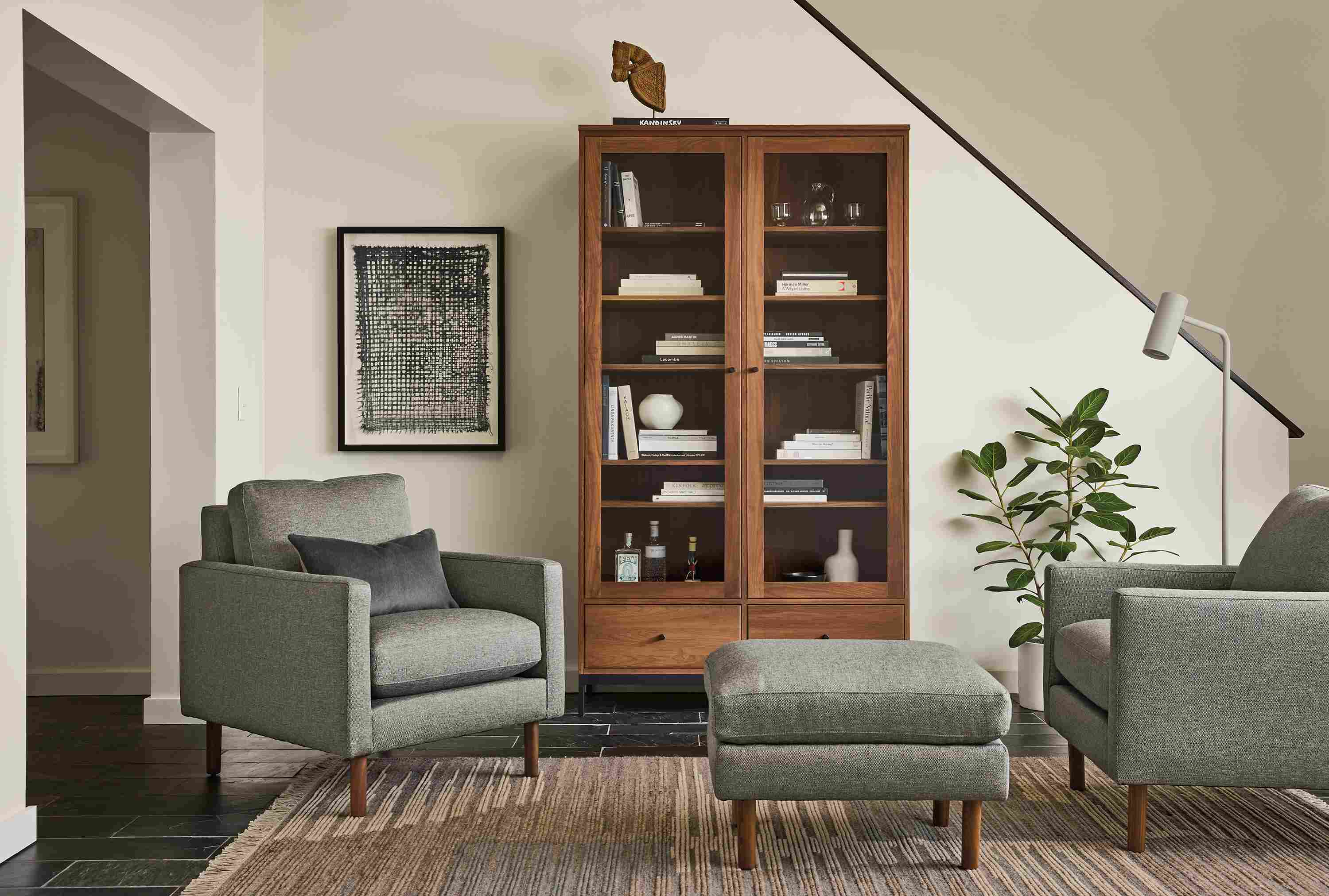 Living room with 2 Jasper chairs, Jasper ottoman in Sumner Graphite and Tangier 6 by 9 rug in natural.