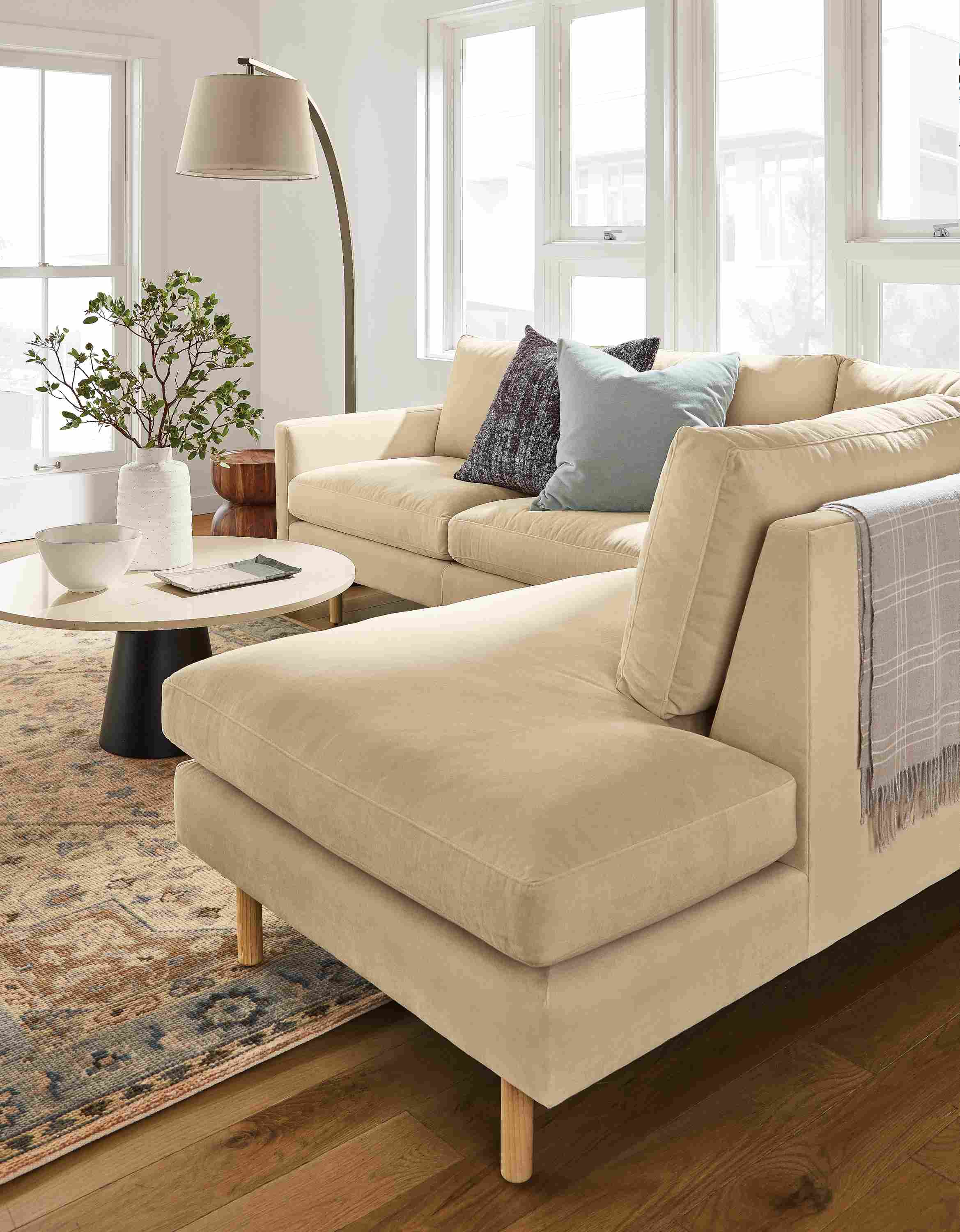 Living room with detail of corner and back on a Jasper sofa with left-corner chaise in View Wheat.