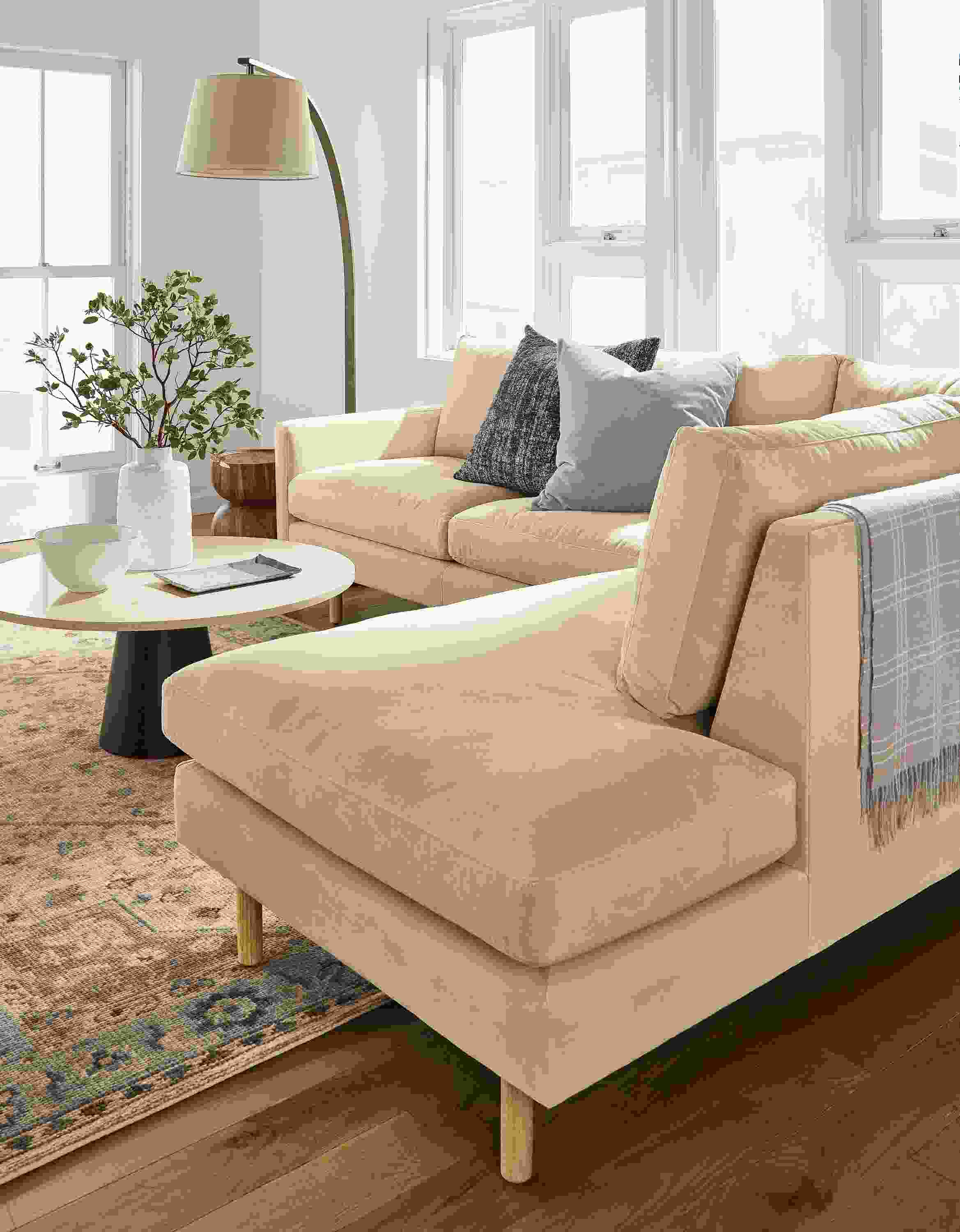 Living room with detail of corner and back on a Jasper sofa with left-corner chaise in View Wheat.