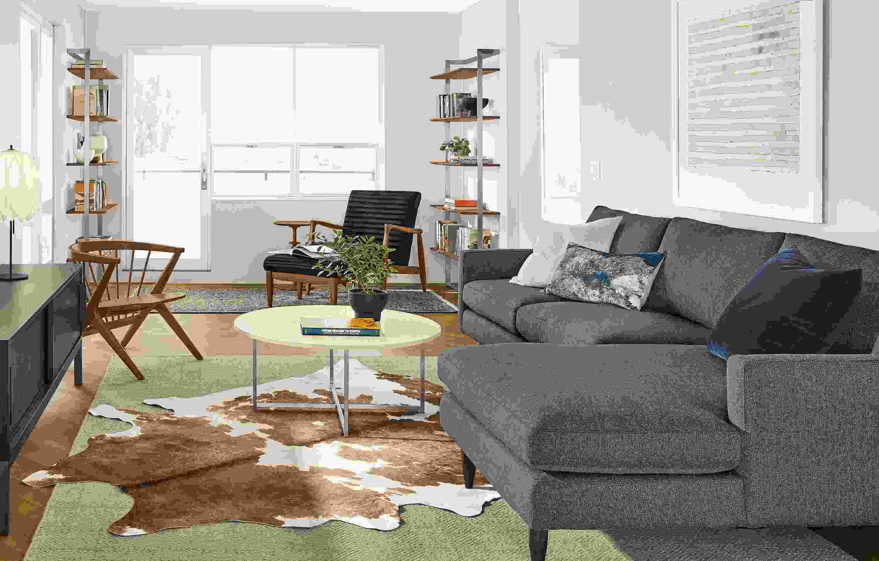 Living room with Jasper sofa with right-arm chaise in Tepic Haze and Callan chair in Urbino black leather.