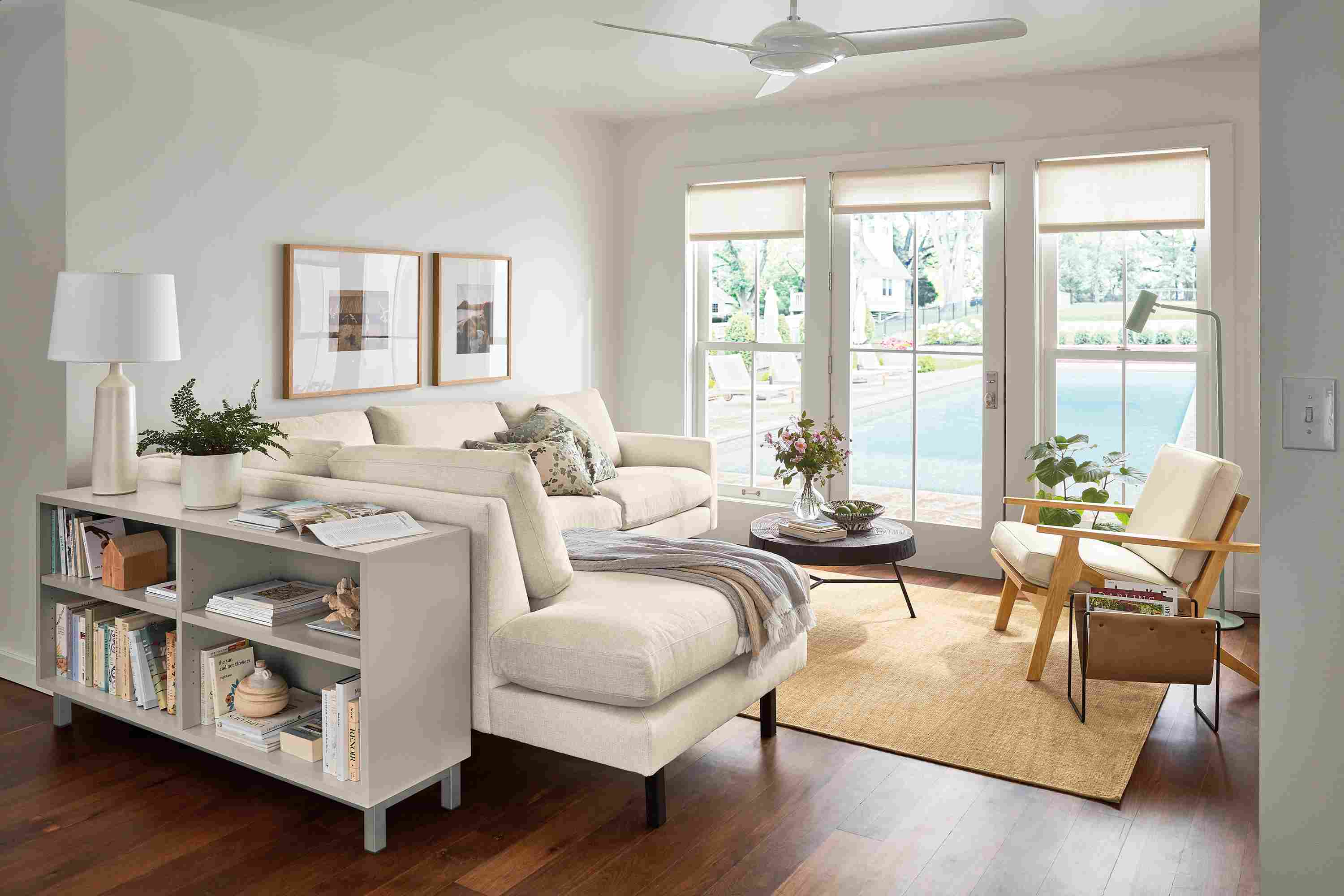 Living room with Jasper sofa in Sumner Ivory, Sanna leather chair, Copenhagen console bookcase in taupe.