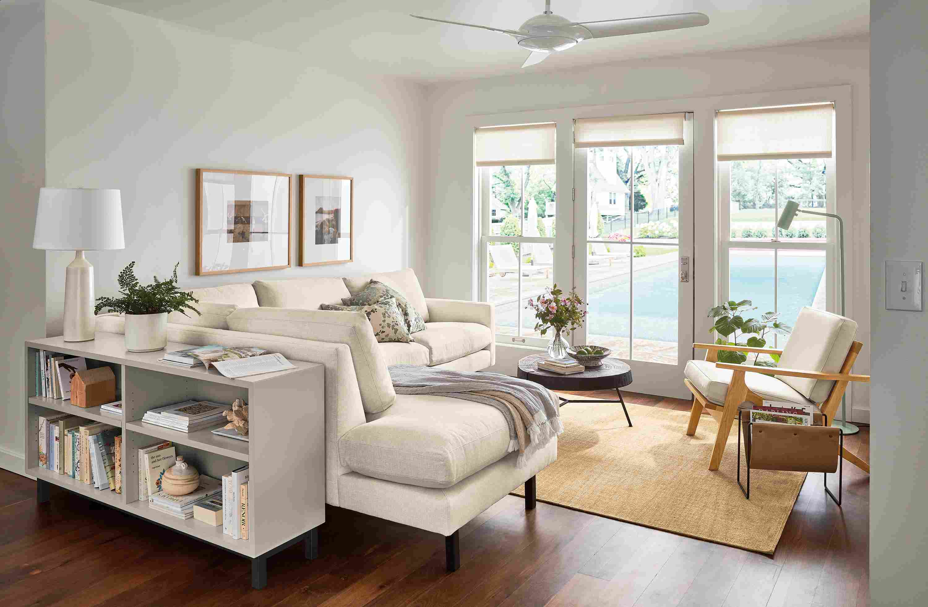 Living room with Jasper sofa in Sumner Ivory, Sanna leather chair, Copenhagen console bookcase in taupe.