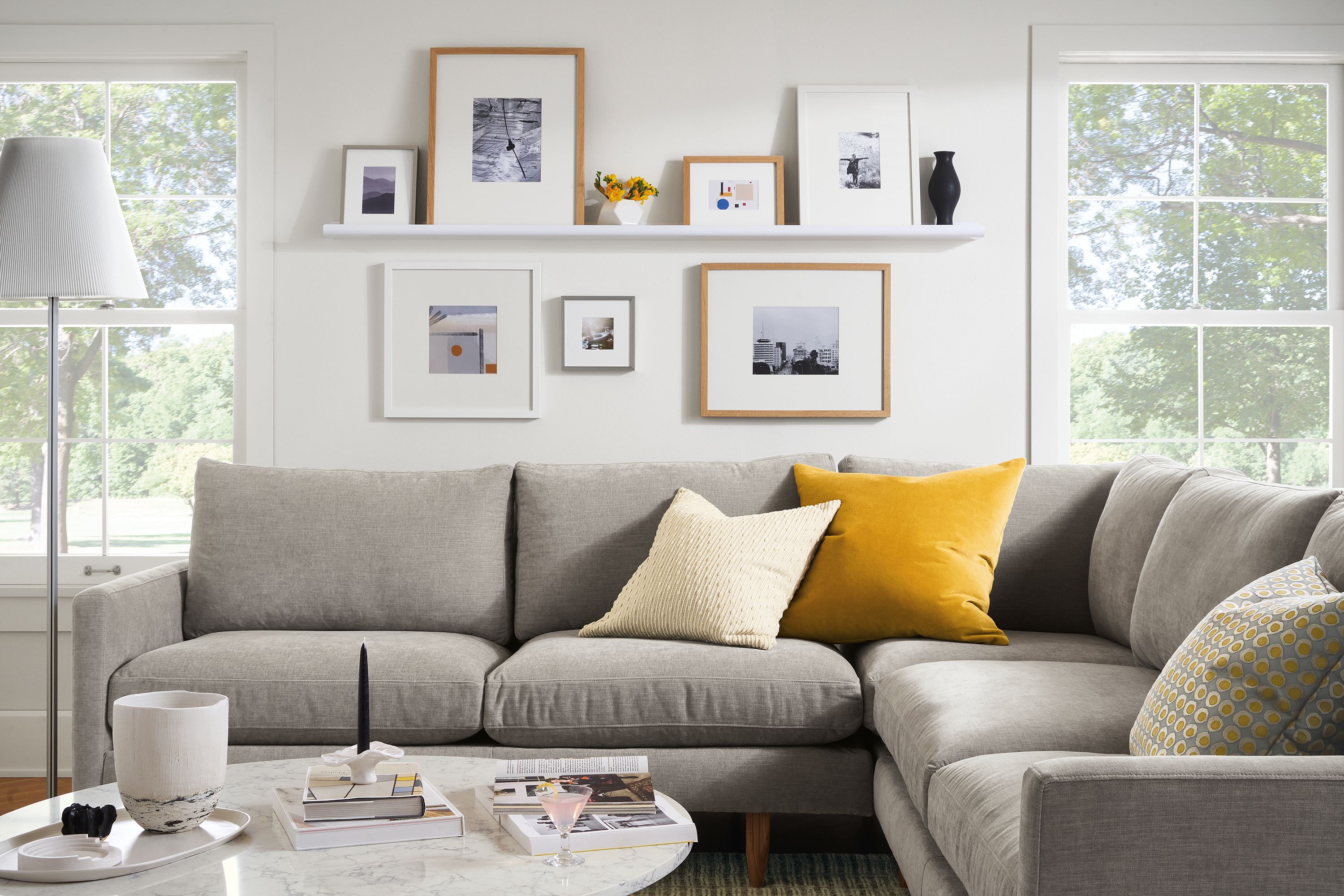 Living room with Jasper sectional sofa in Mori Cement, Aria coffee table with marbled white quartz top.