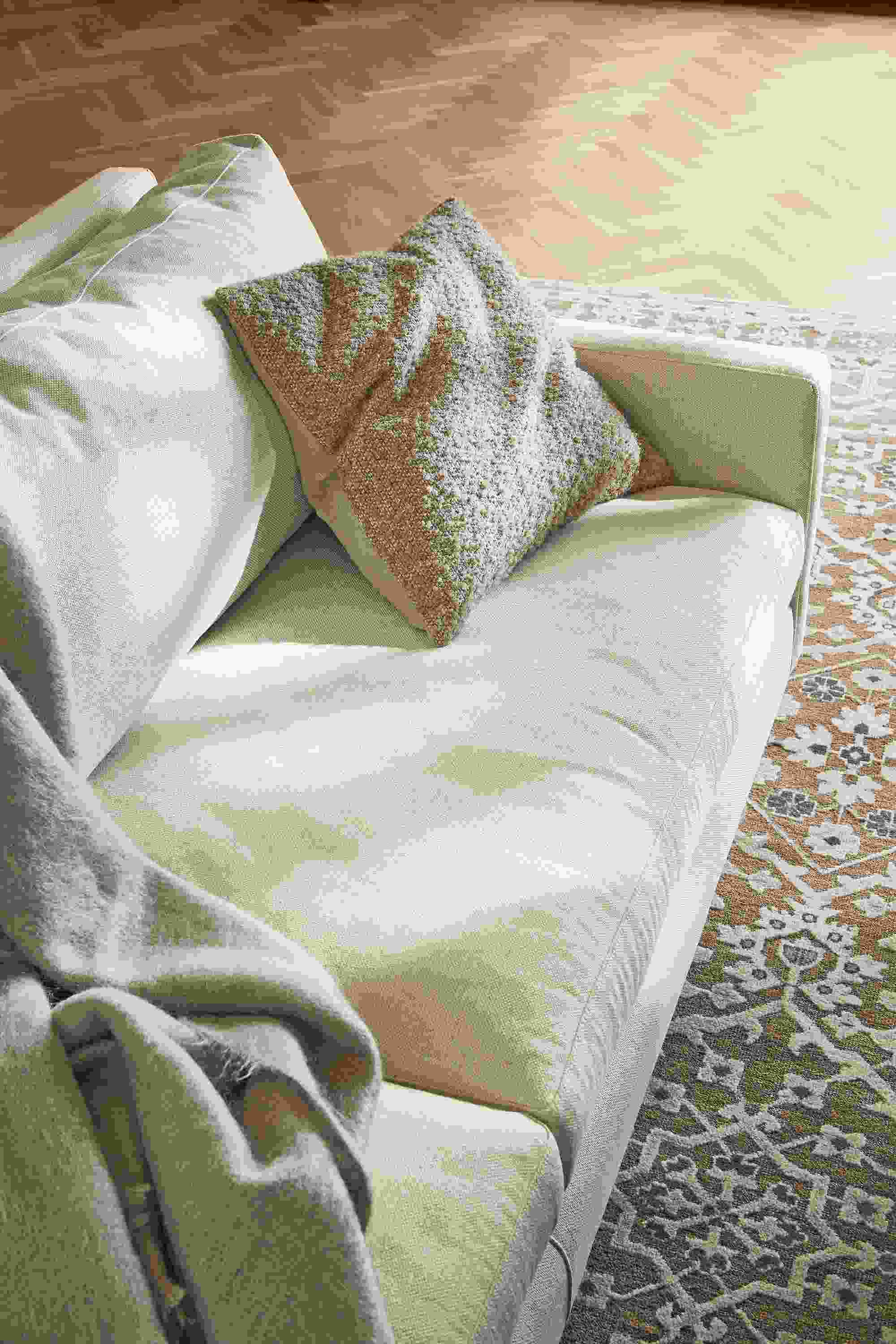 Close-up of Palmer throw pillow on Jasper sofa in Sumner Ivory.