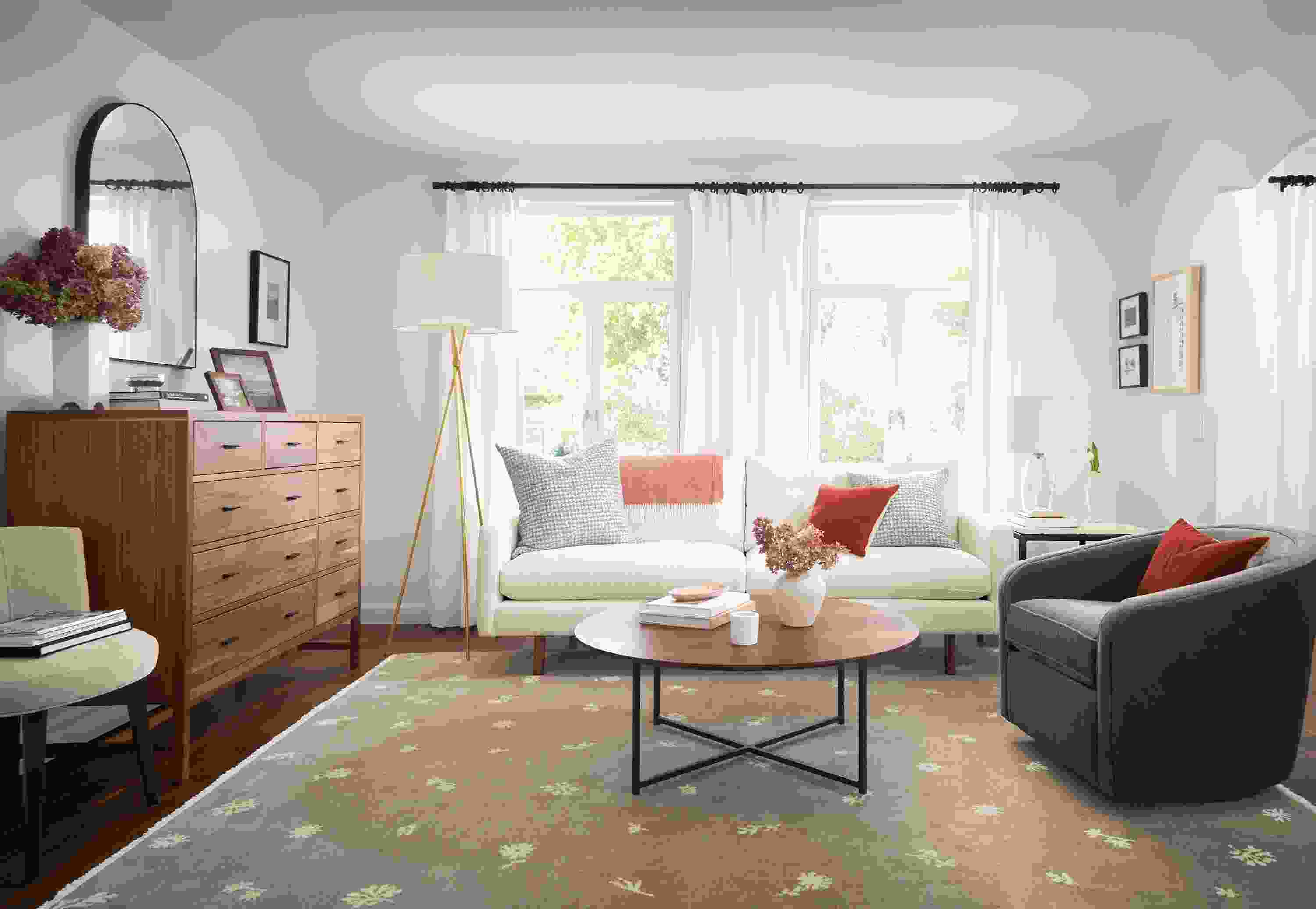 Living room with Jasper sofa in white, Tansy rug in Taupe/Ivory, and berekely storage cabinet in walnut.