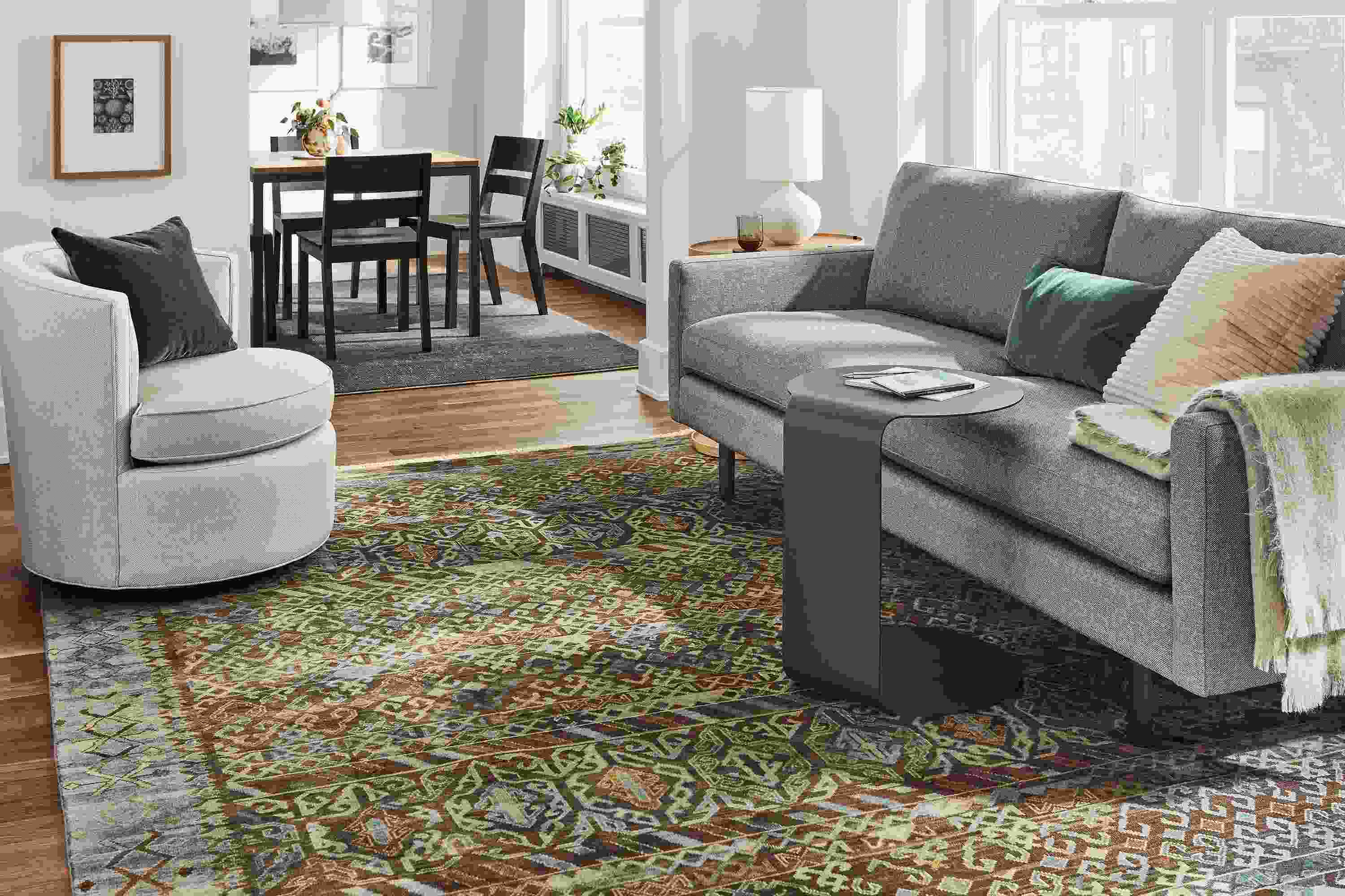 Jasper sofa in Sumner Graphite in living room with c-table and Otis swivel chair in Gino Oatmeal.