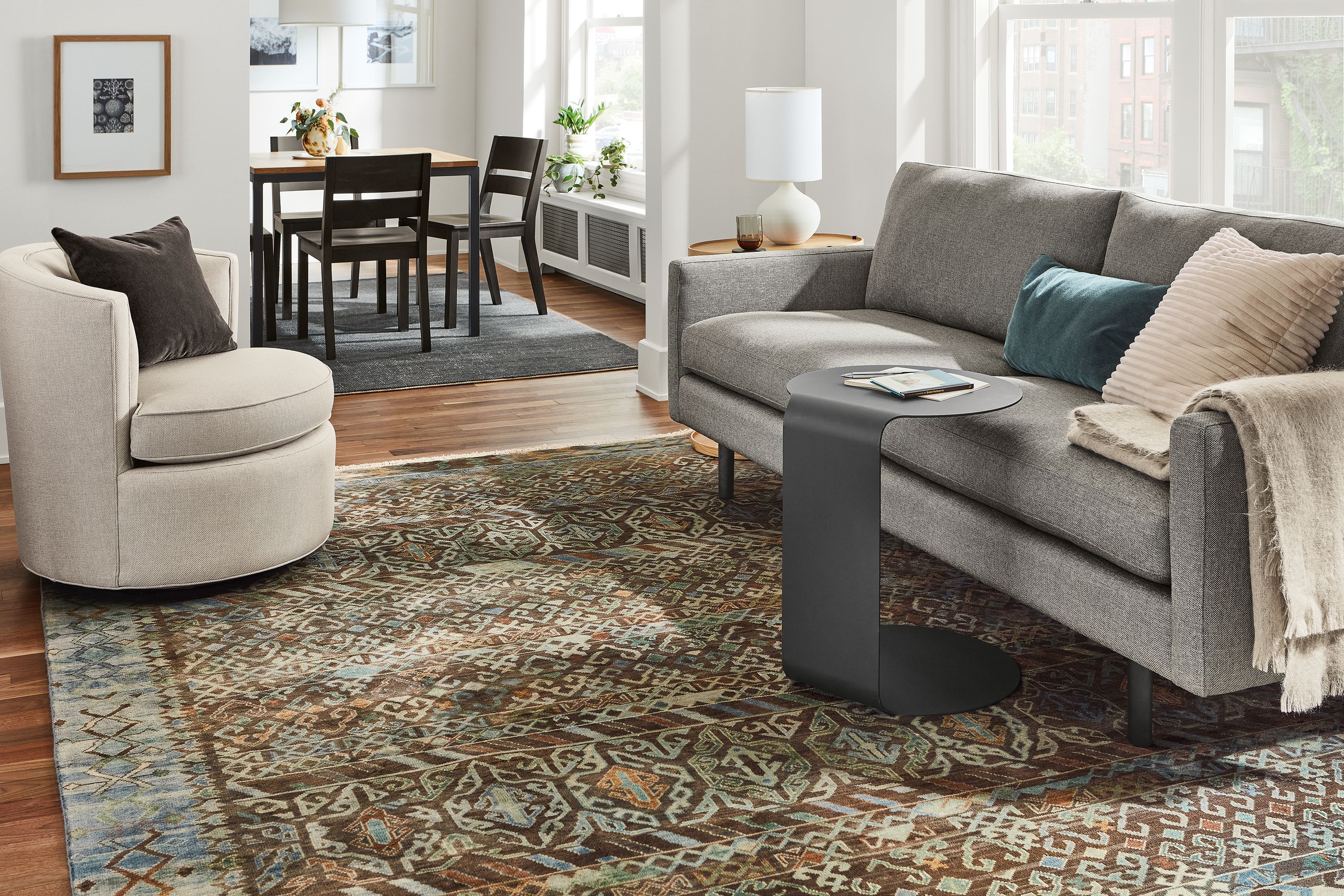 jasper sofa in sumner graphite in living room with c-table and swivel chair.