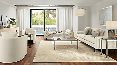 living room with white jasper sofa, pierson white leather daybed, two white silva chairs, bria rug in ivory.