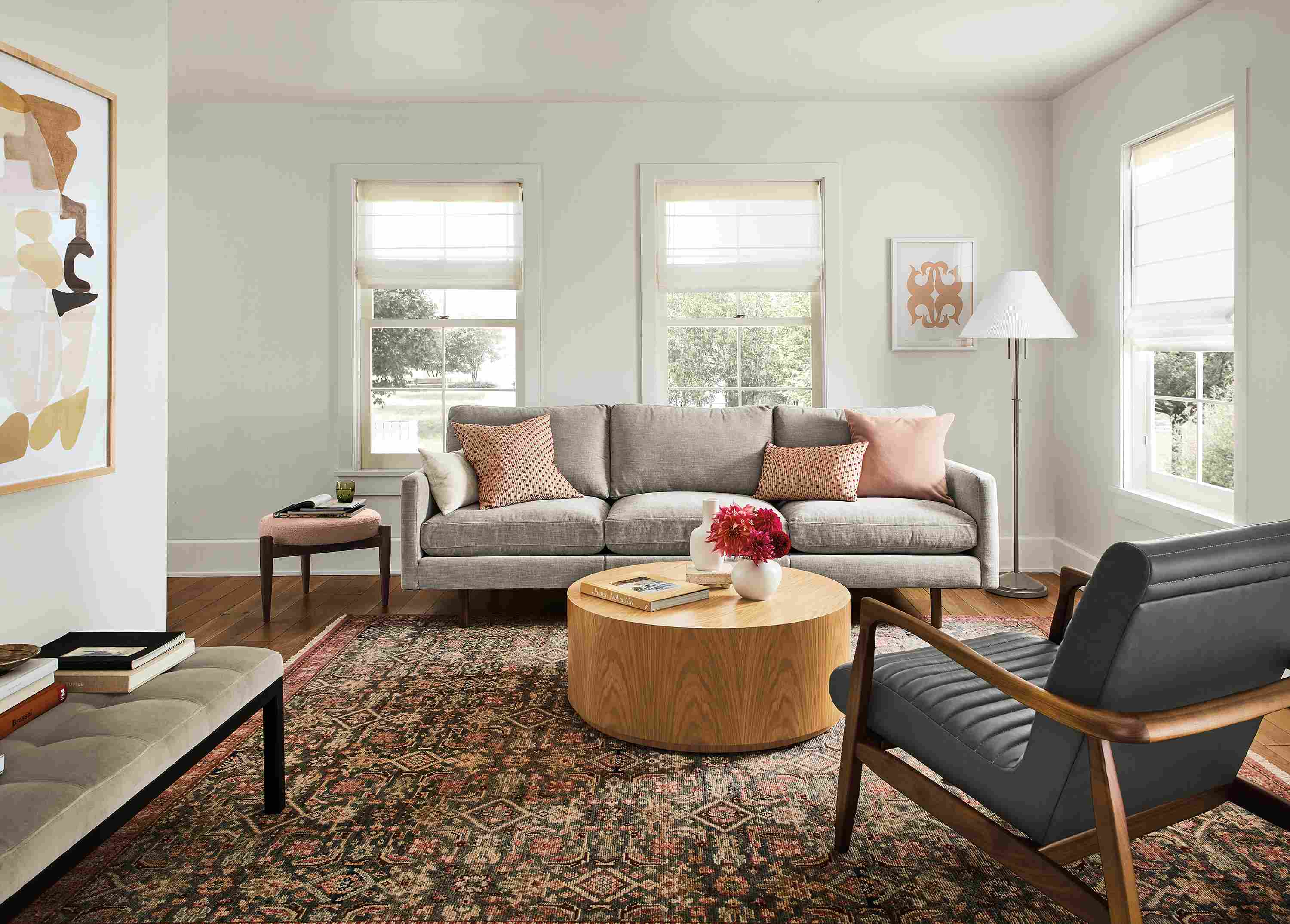 Living area with Jasper sofa in Mori Cement, Callan chair in Laino Slate leather and Liam coffee table in White Oak.