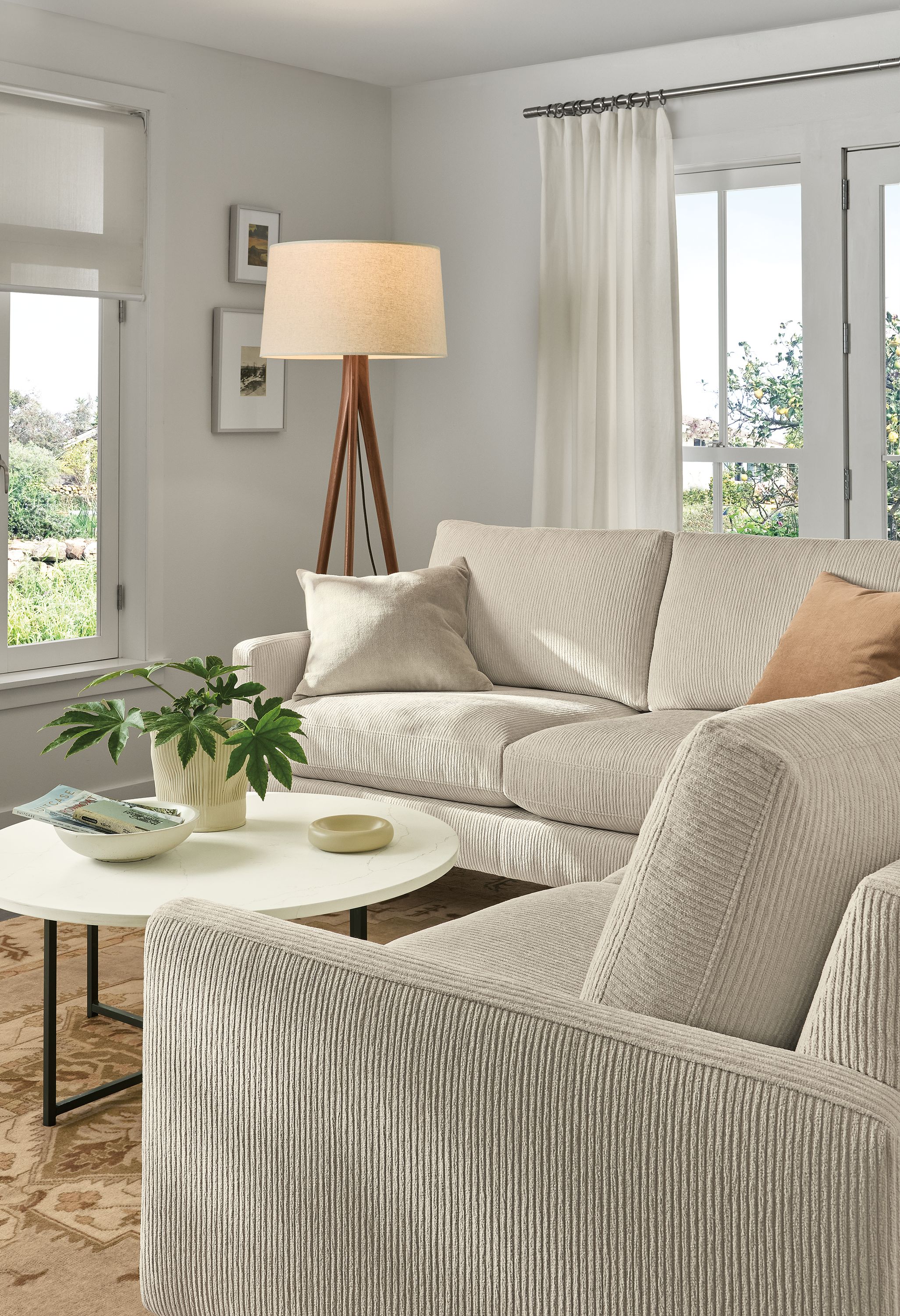 Living room with Jasper 103 by 103 sectional in Brava Ivory and Classic round coffee table with marble ivory quartz top.