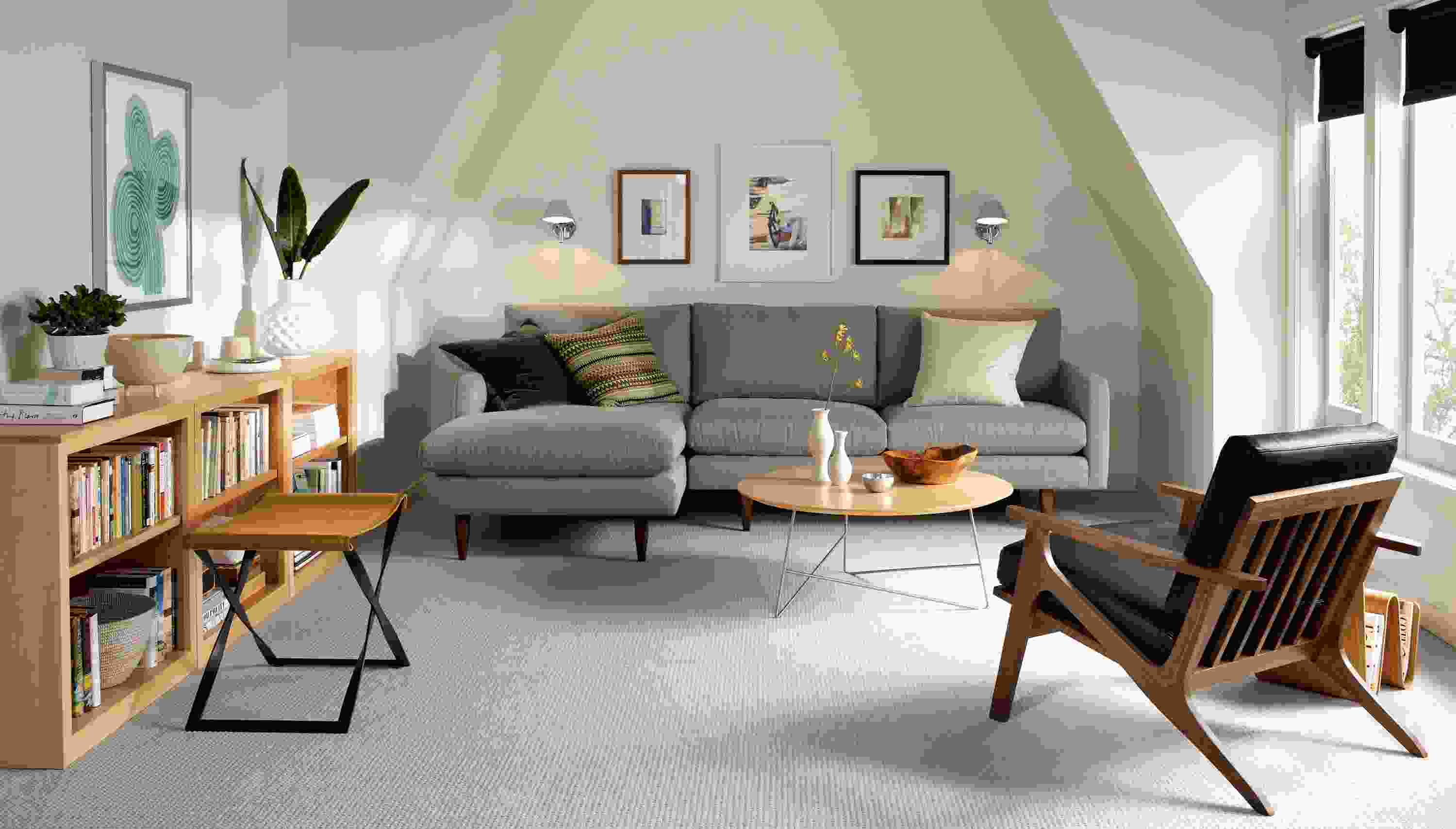Living room with Jasper sofa in Dawson Cement and 3 Woodwind bookcases in Maple.