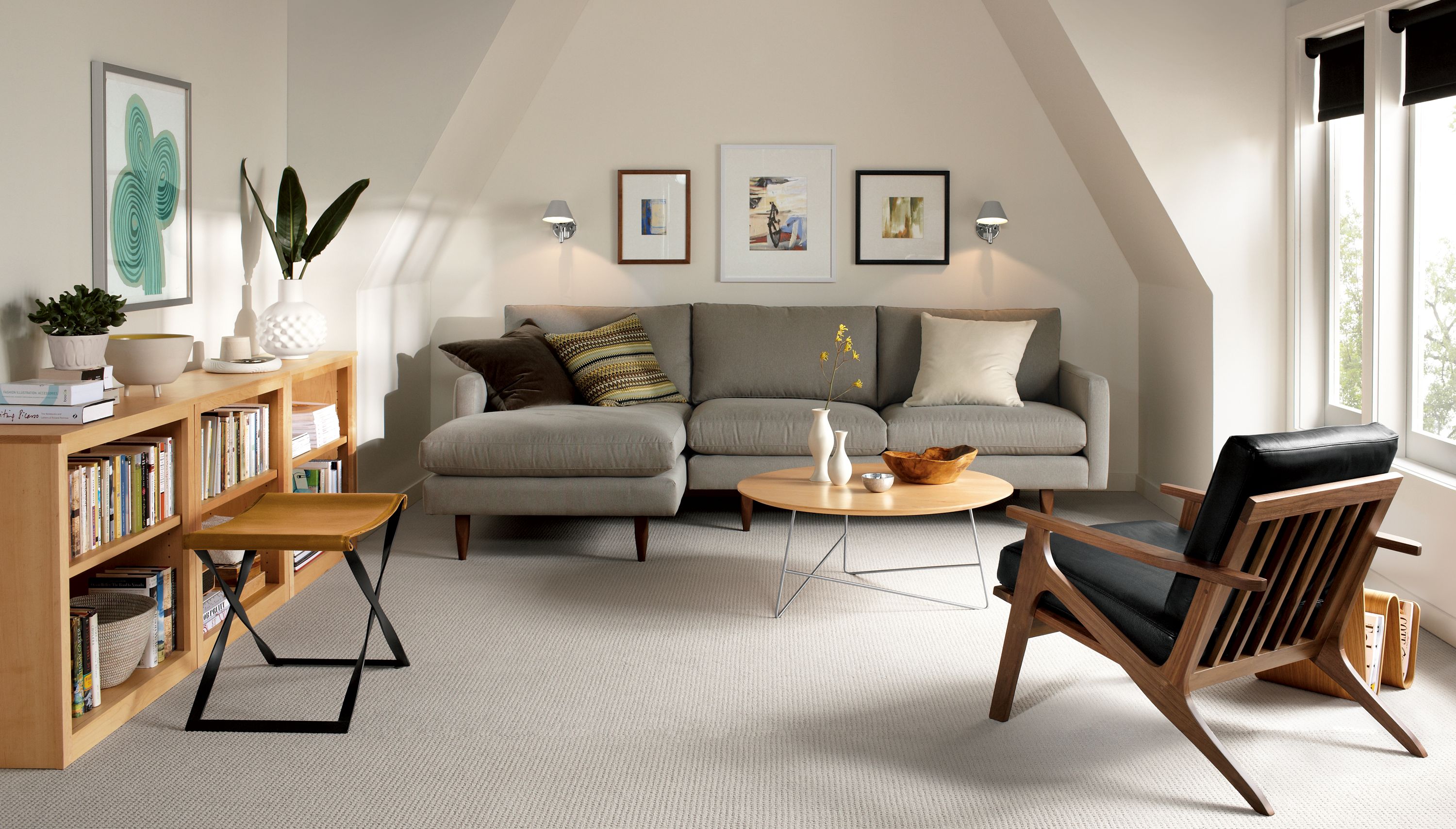Living room with Jasper sofa in Dawson Cement and 3 Woodwind bookcases in Maple.