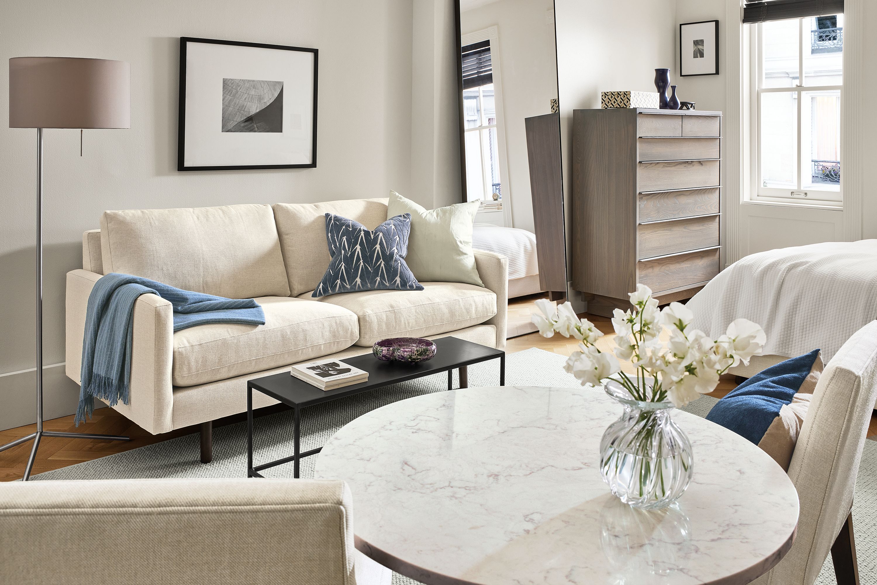 Living room with Jasper 71-wide loveseat in Sumner Ivory, and Aria 27-inch diameter table with marbled white quartz top.