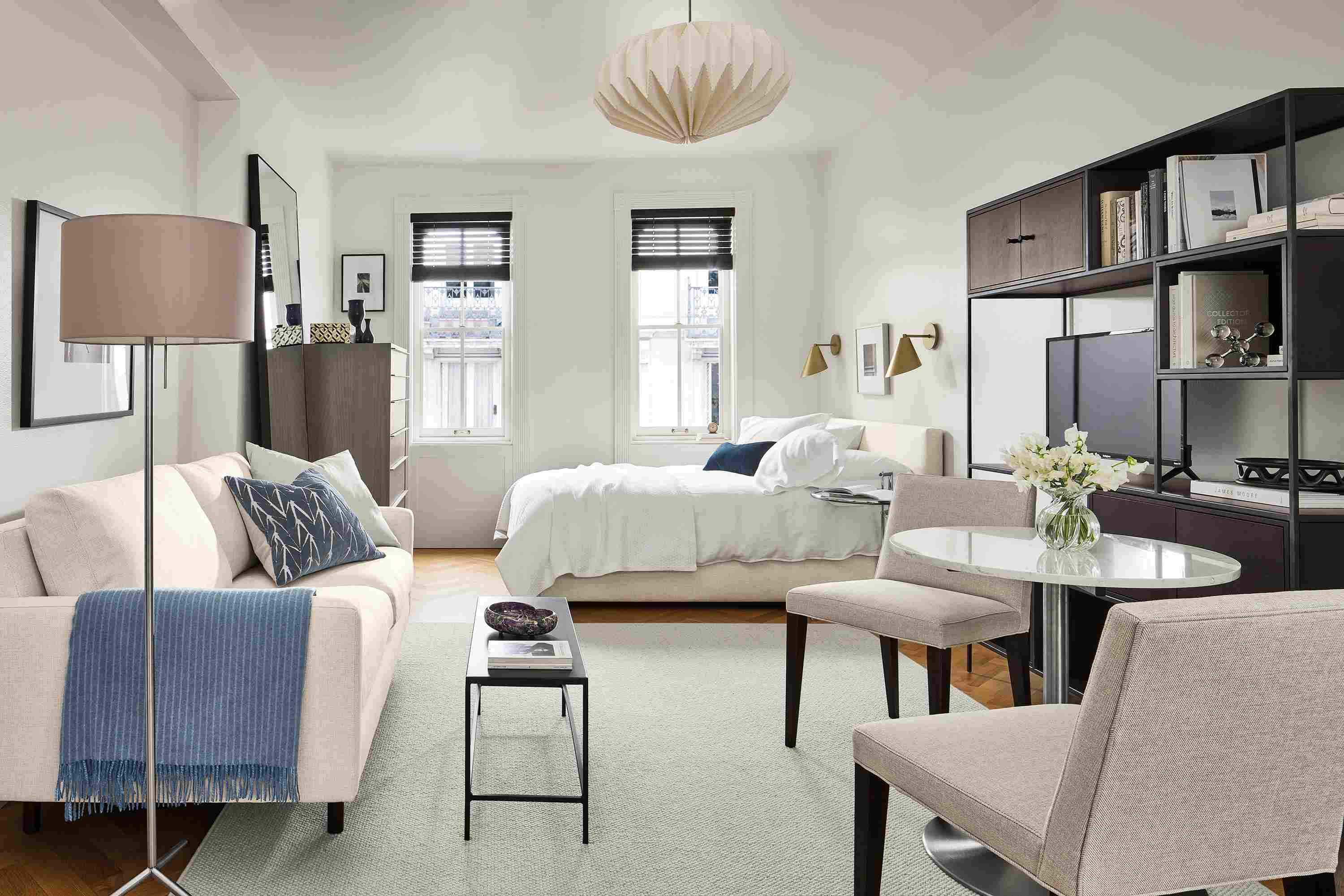 Studio apartment with Jasper 71-wide loveseat, Wyatt full bed in Sumner Ivory, Aria 27-diameter table, and Flannery rug in grey.