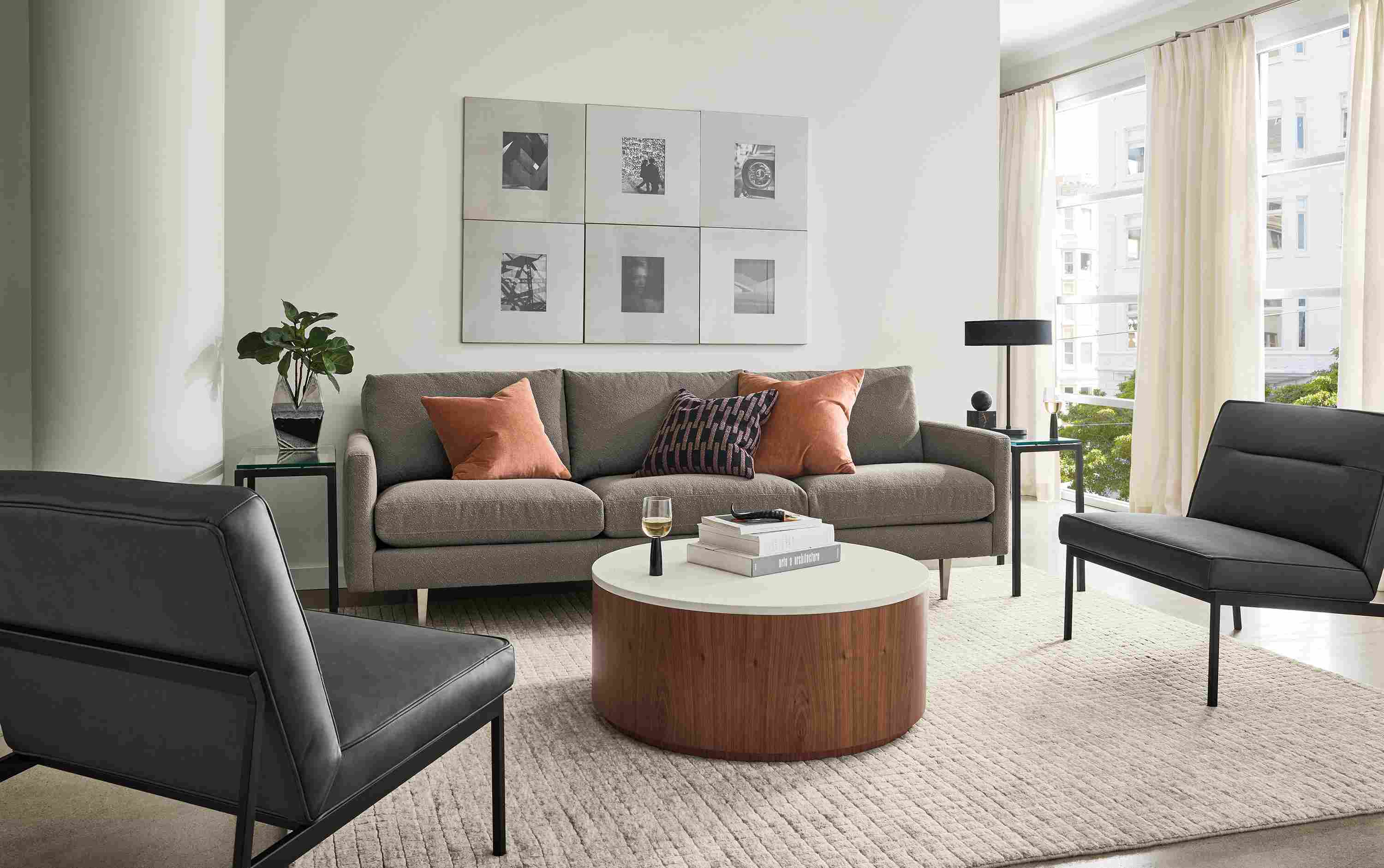 Living room with Jasper 96-wide sofa in Declan Putty, 2 Lisbon chairs in Laino Black leather and Safira rug.