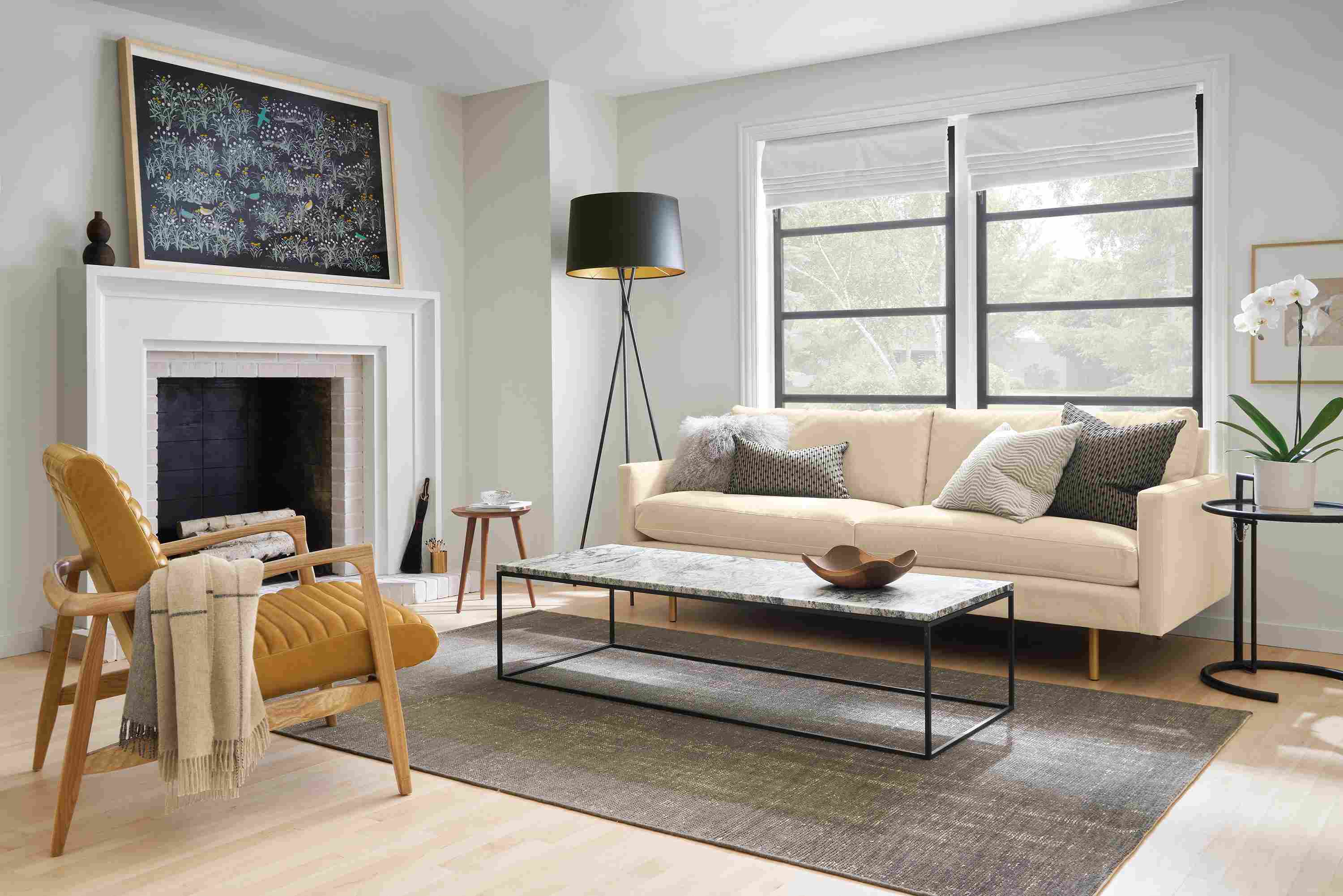 Living room with Jasper sofa in View Wheat, Callan chair in Vento Camel leather and Eileen Grey table in black.