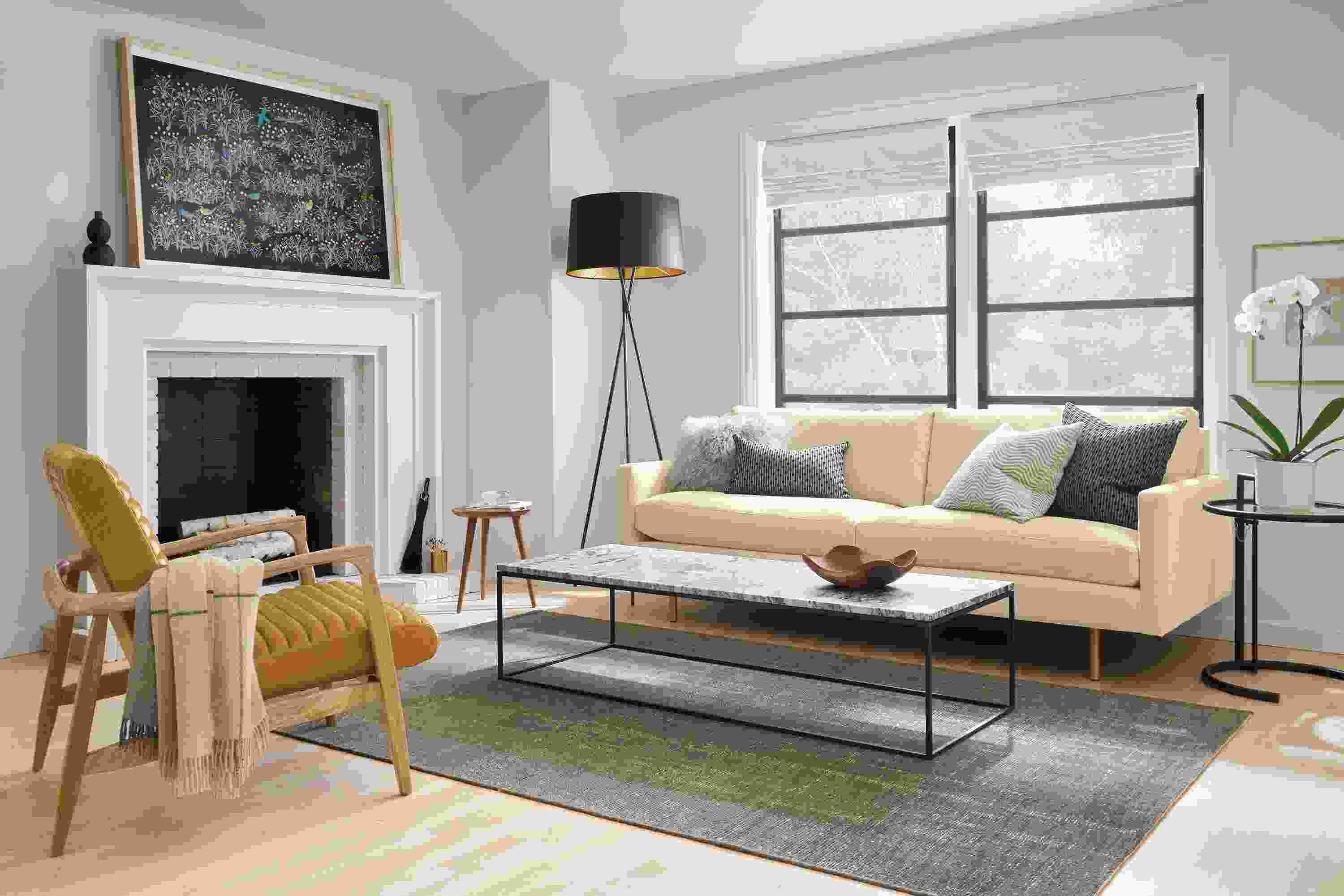 Living room with Jasper sofa in View Wheat, Callan chair in Vento Camel leather and Eileen Grey table in black.