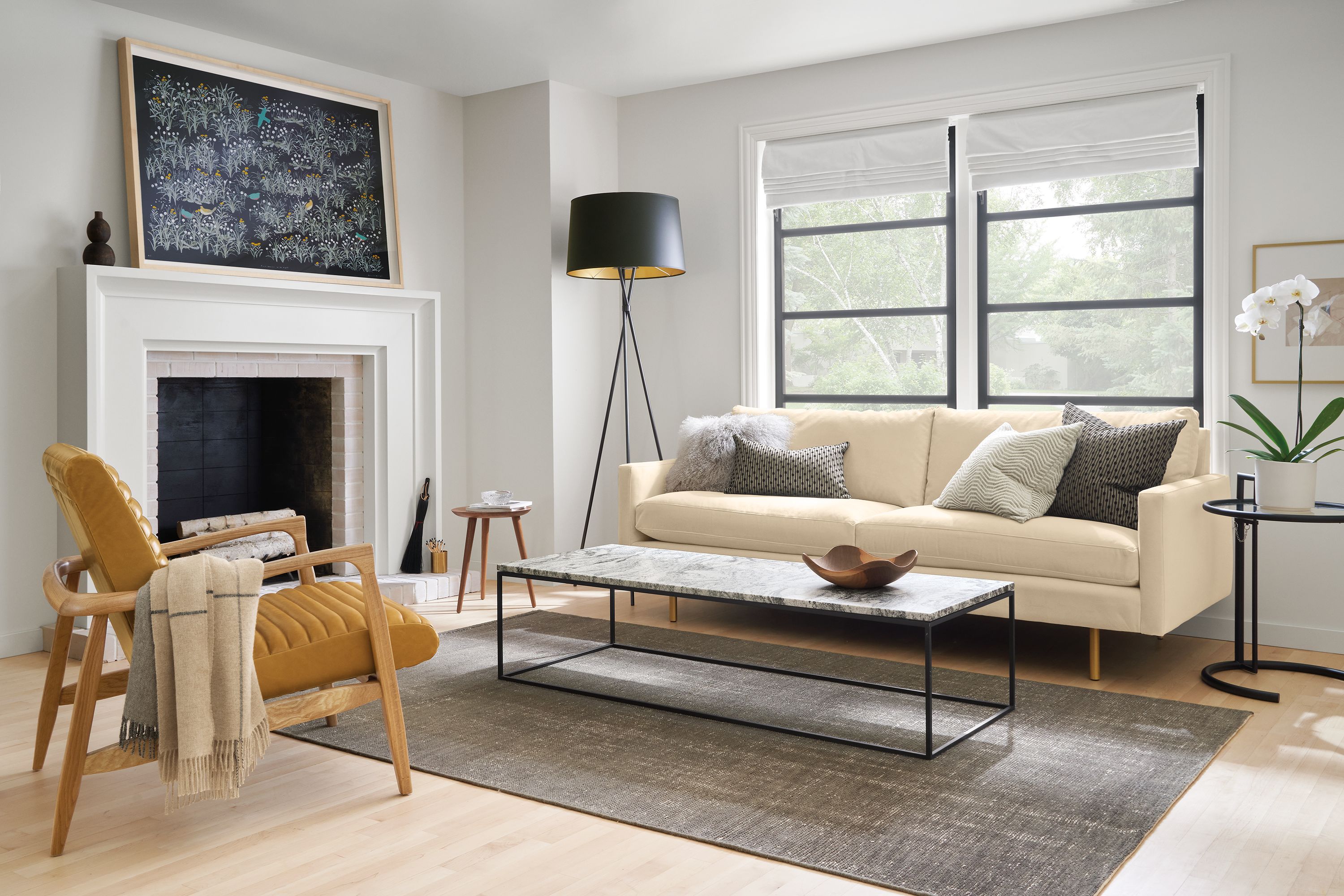 Living room with Jasper sofa in View Wheat, Callan chair in Vento Camel leather and Eileen Grey table in black.