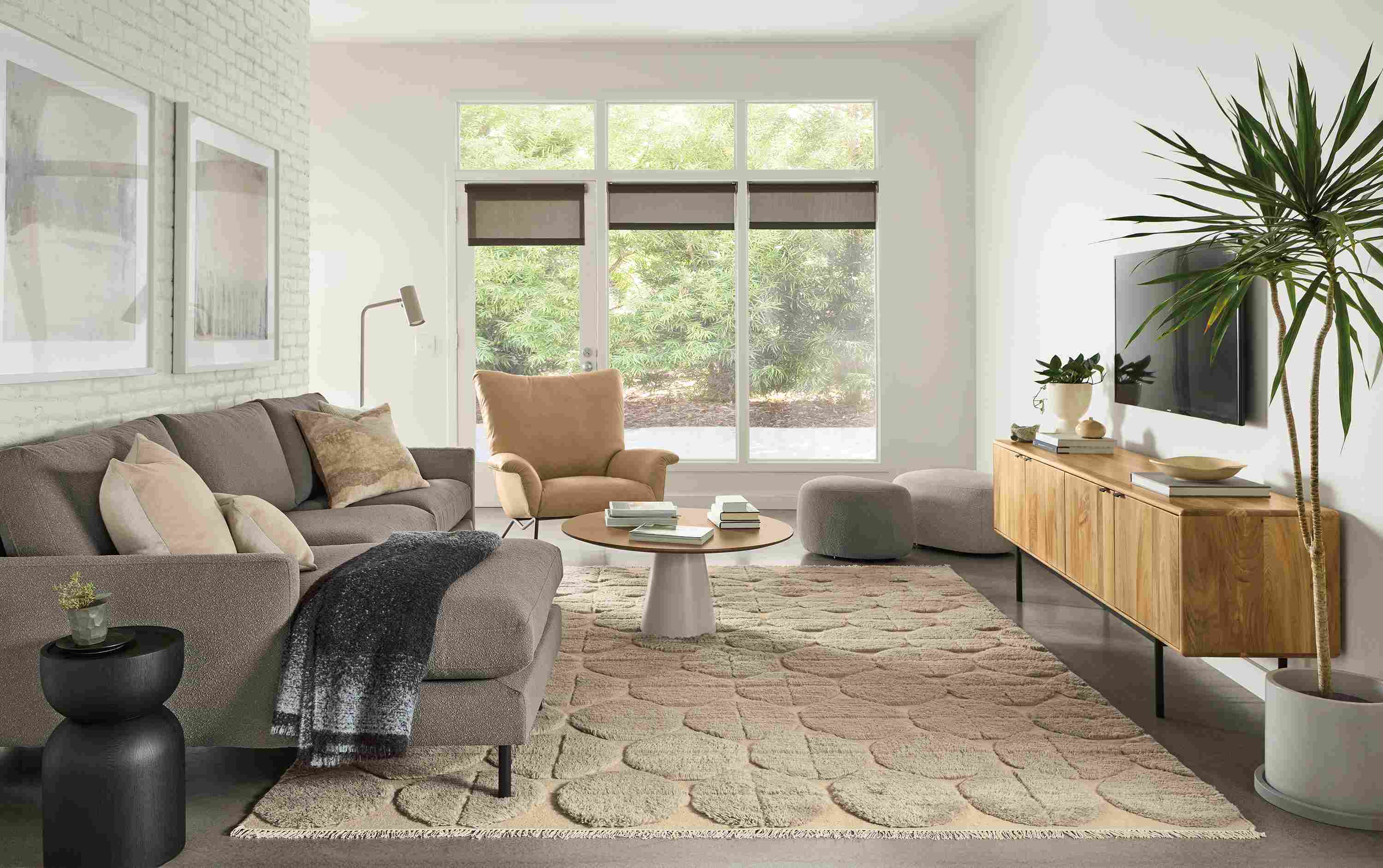 Living room with Jasper 104-wide sofa in Declan Putty, Paris chair in Fiero Camel leather and Edo rug in Asphalt.