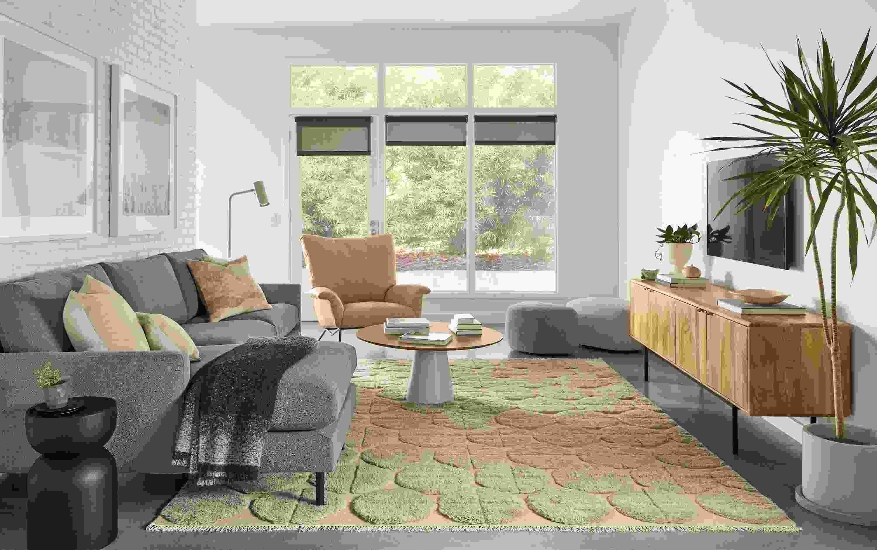 Living room with Jasper 104-wide sofa in Declan Putty, Paris chair in Fiero Camel leather and Edo rug in Asphalt.