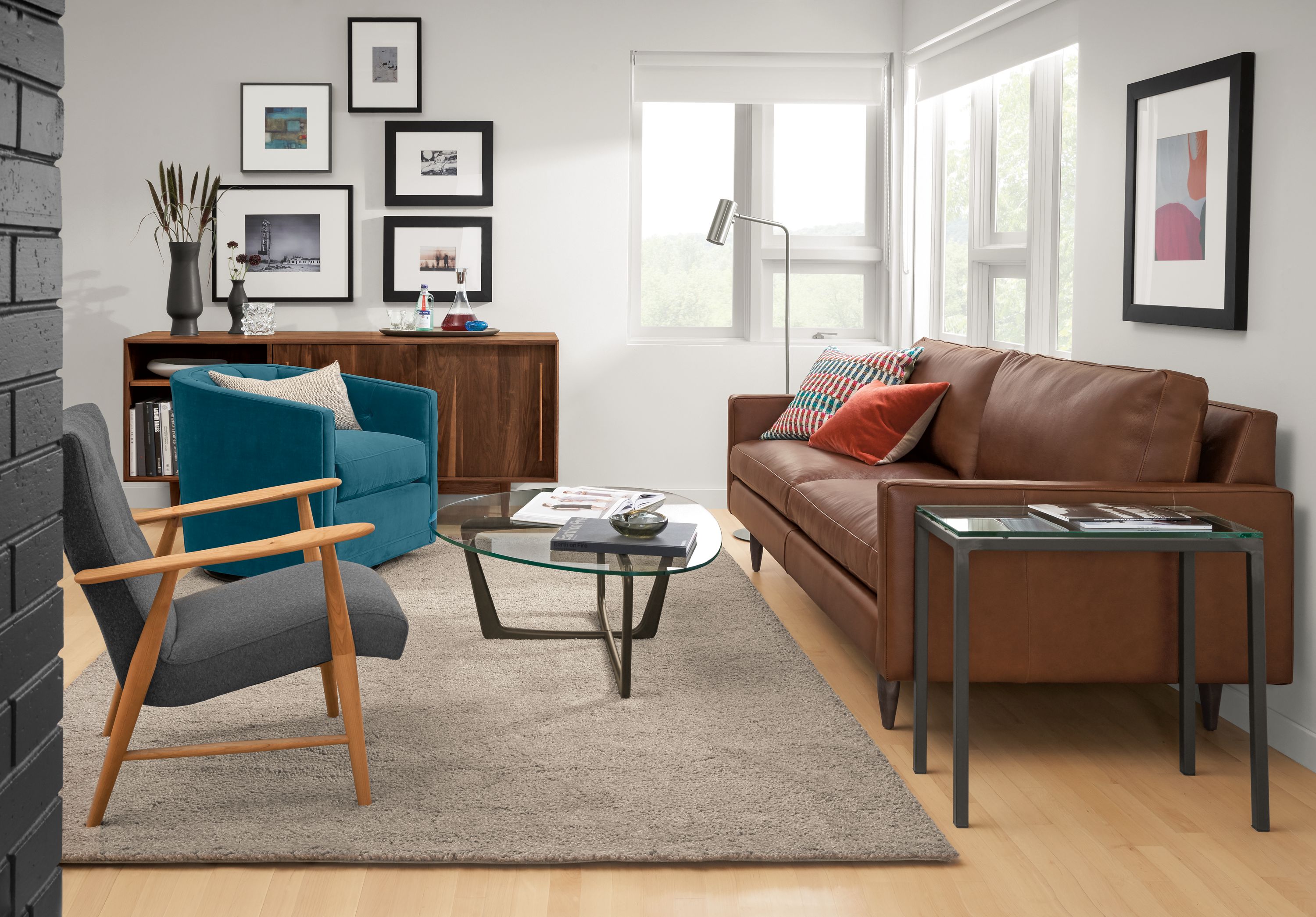 Living room with Jasper 86-wide sofa in Lecco Cognac, Jonas chair in Flint Charcoal and Arden rug in Taupe.