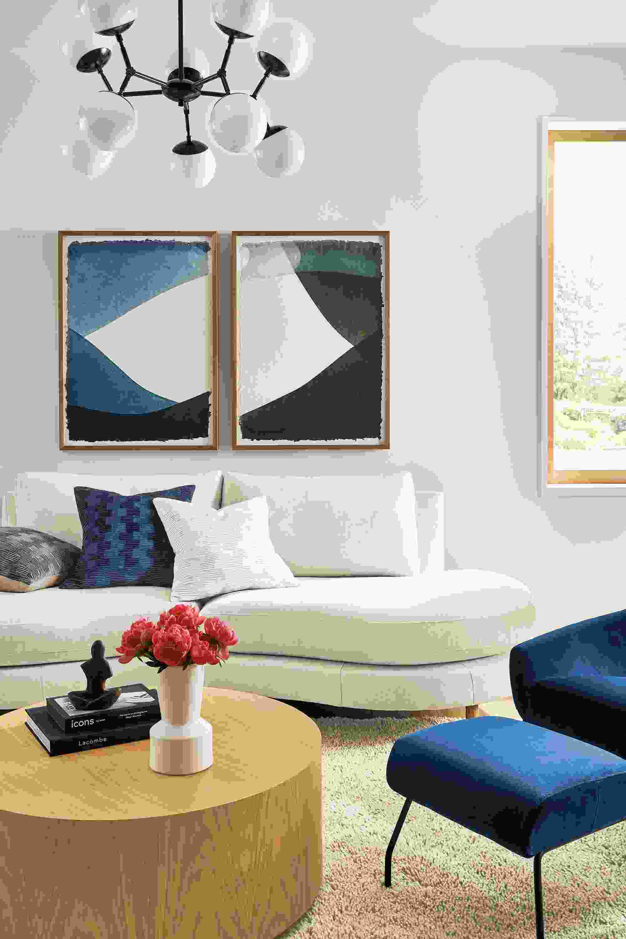 Living room with Jasper curved sofa in Sumner Ivory, Cosma chandelier, Liam coffee table.