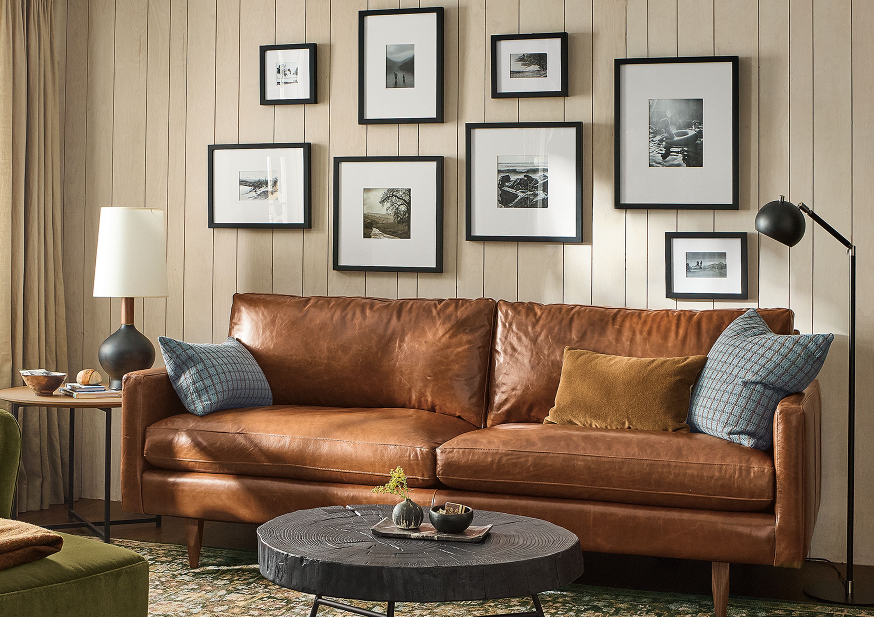 Living room with Jasper 86-wide sofa in Vento Cognac leather and Lily chair and ottoman in Redding Olive.