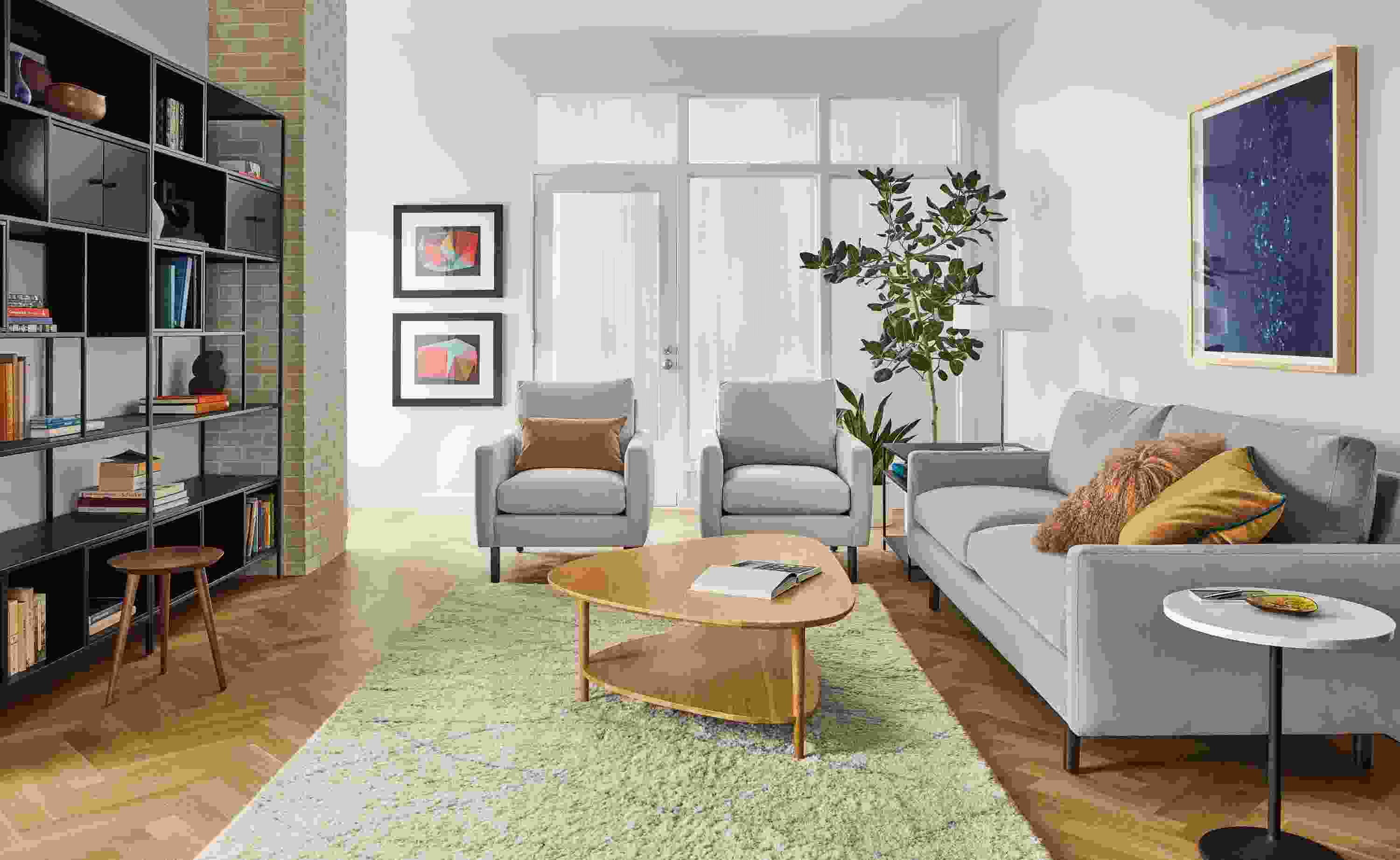 Living room with Jasper sofa and two chairs in View Grey fabric, Gibson coffee table in white oak and Kalindi rug in cement.