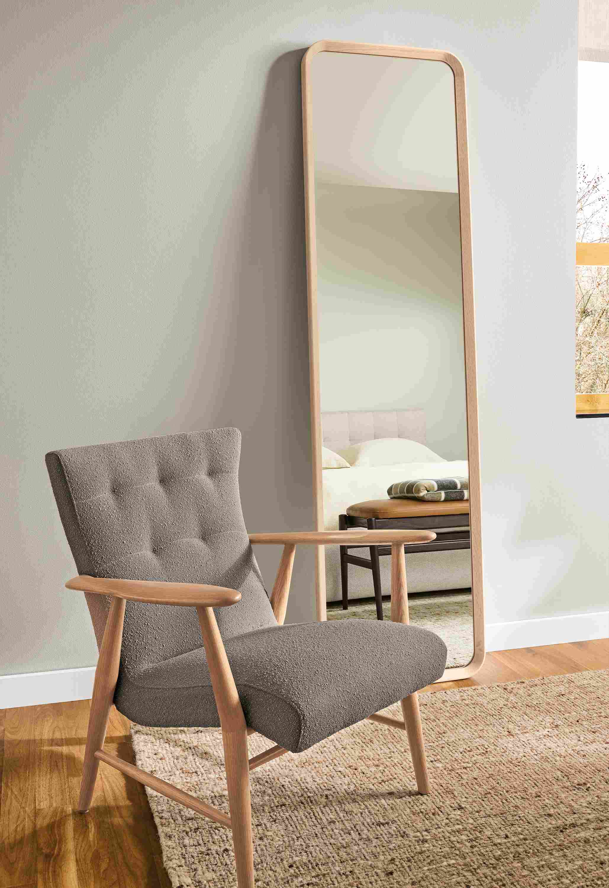 Living room with Jonas lounge chair in Declan Putty, Donahue floor mirror in salt on red oak and Ravani rug in oatmeal.