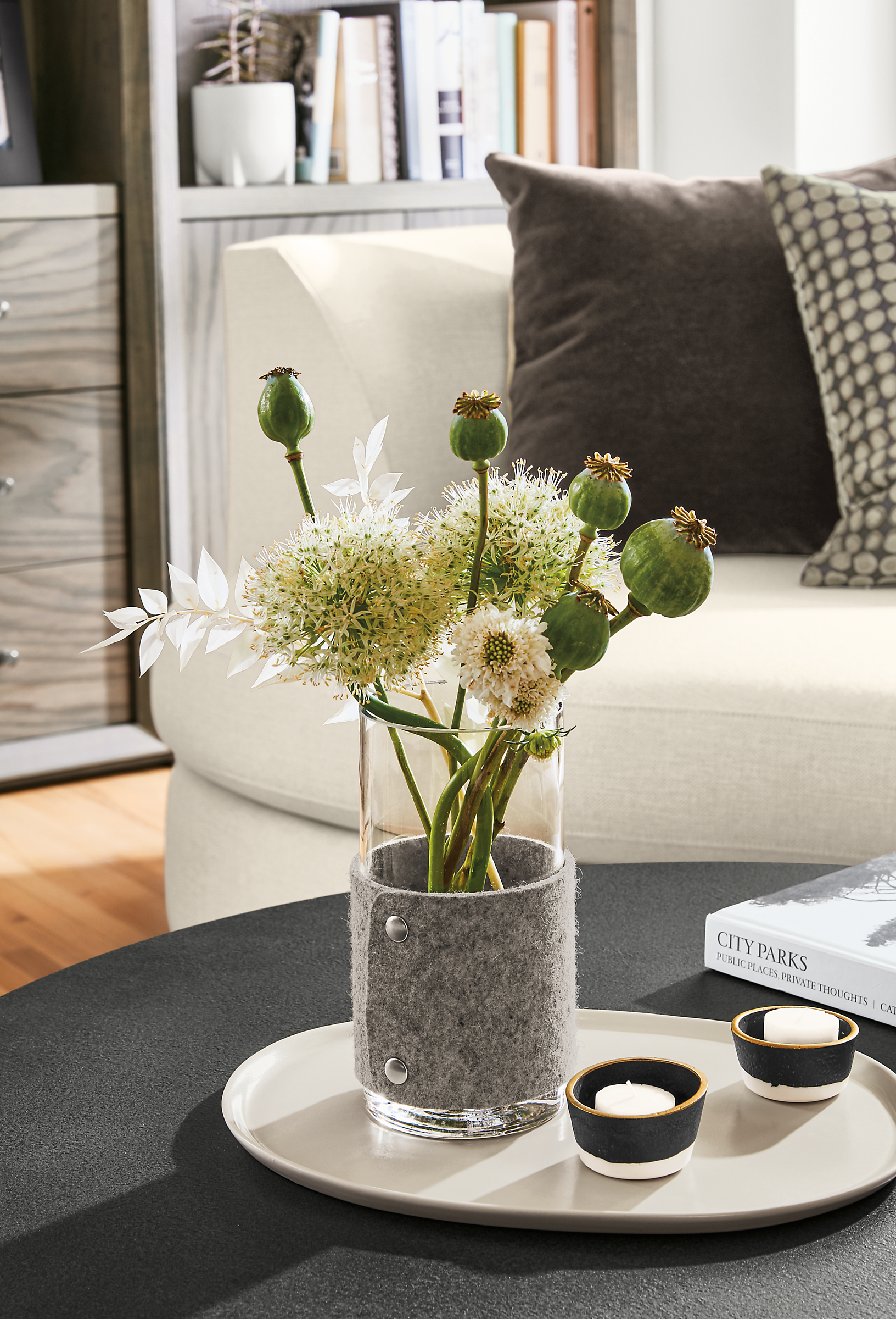 Detail of Judd vase in grey felt on coffee table.