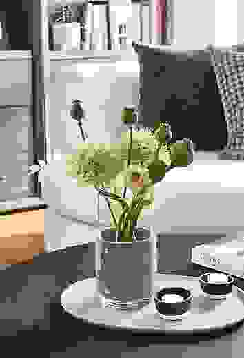 Detail of Judd vase in grey felt on coffee table.