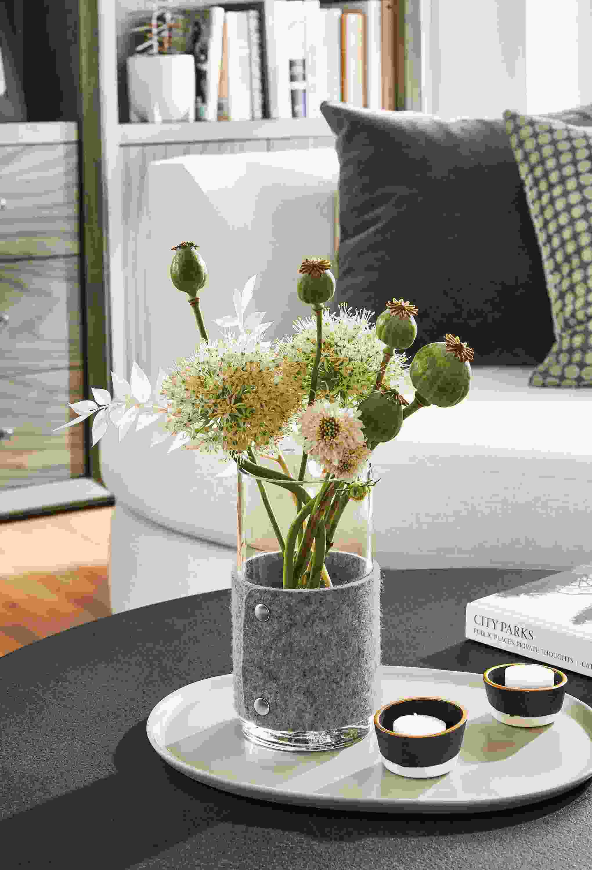 Detail of Judd vase in grey felt on coffee table.