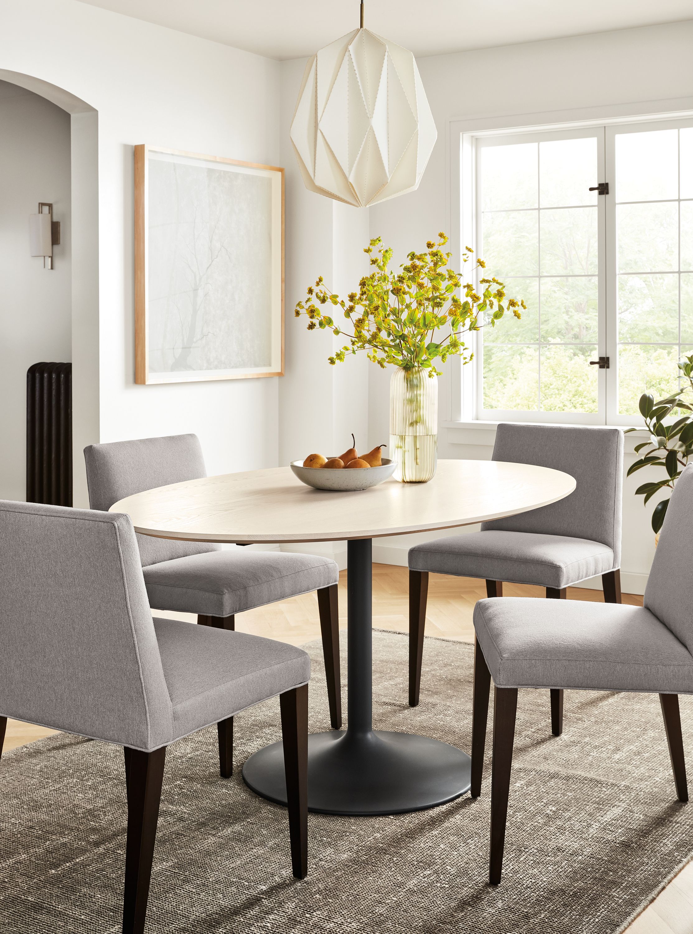 dining room with julian oval table, ava side chairs, samar rug, ayomi yoshida print, orikata pendant.