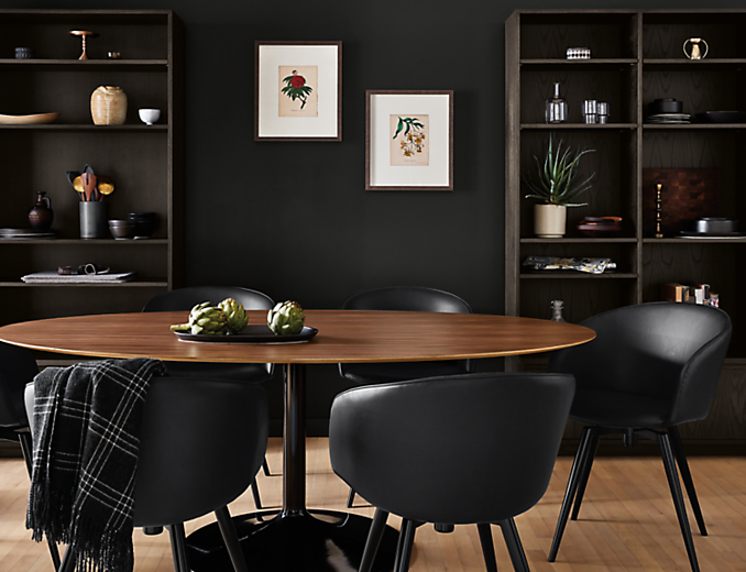 dining room with black decor with julian oval table with walnut top and black base.