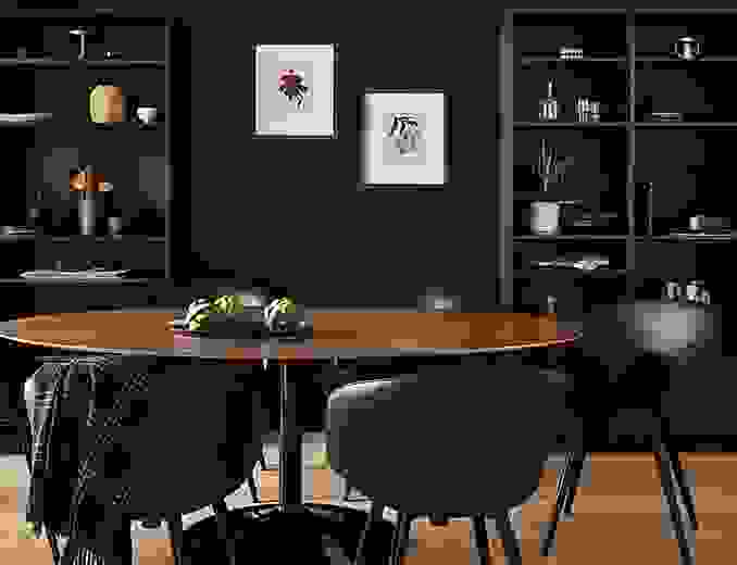 dining room with black decor with julian oval table with walnut top and black base.