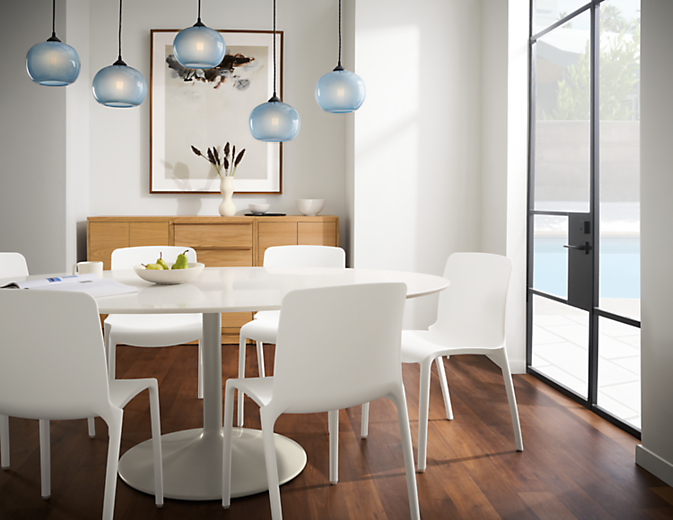 dining room with white julian table, tiffany side chairs in white, gale pendants set in blue.