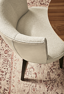 Detail of June side chair with fabric seat and leather back in dining room with Cassia rug.