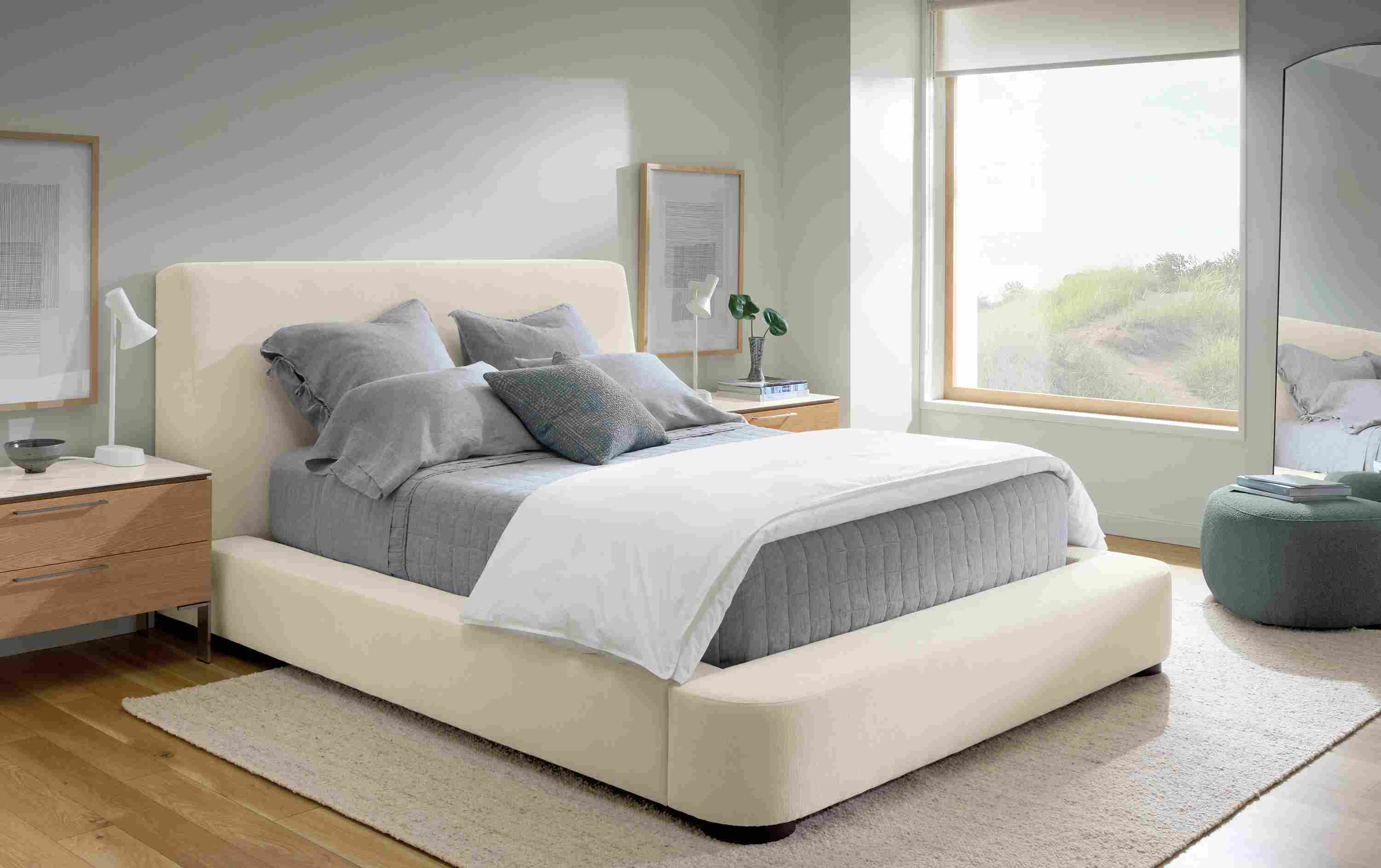 Bedroom with Kai queen bed in Crawford Ivory, 2 Kenwood nightstands in rye on red oak and Sefton rug in cement.