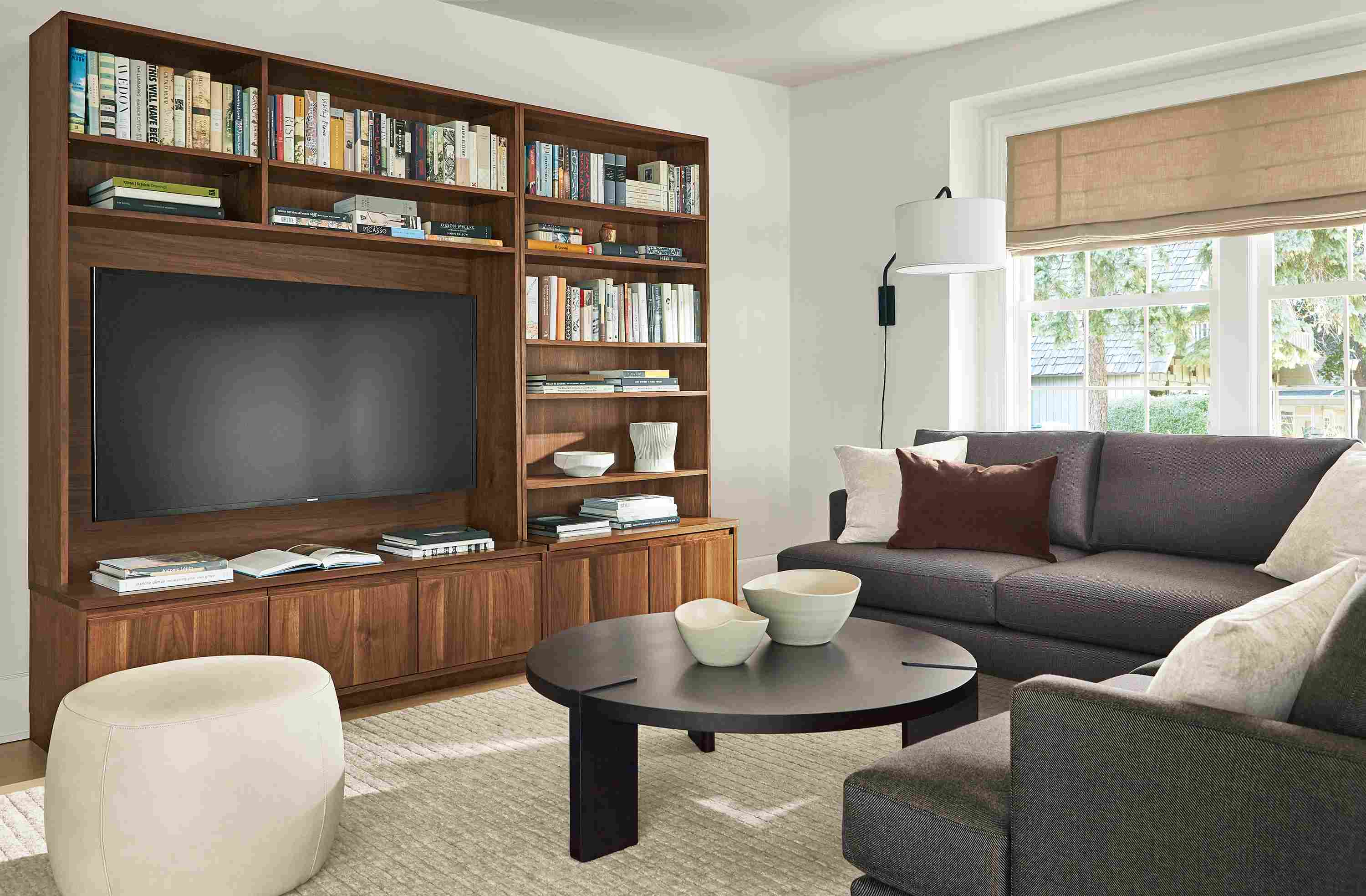 Living room with Keaton 98-wide media wall unit in walnut, Carlton sectional, Hanover coffee table and Lind ottoman.