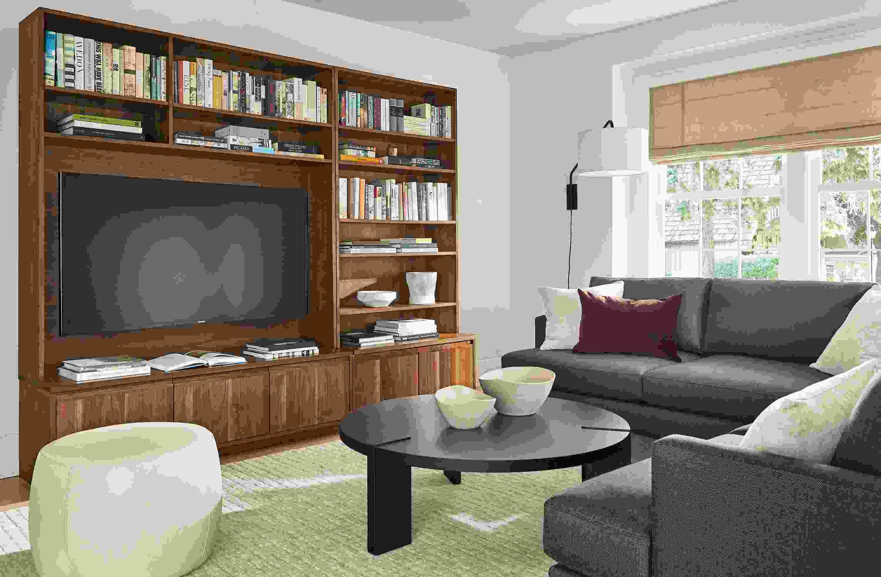 Living room with Keaton 98-wide media wall unit in walnut, Carlton sectional, Hanover coffee table and Lind ottoman.