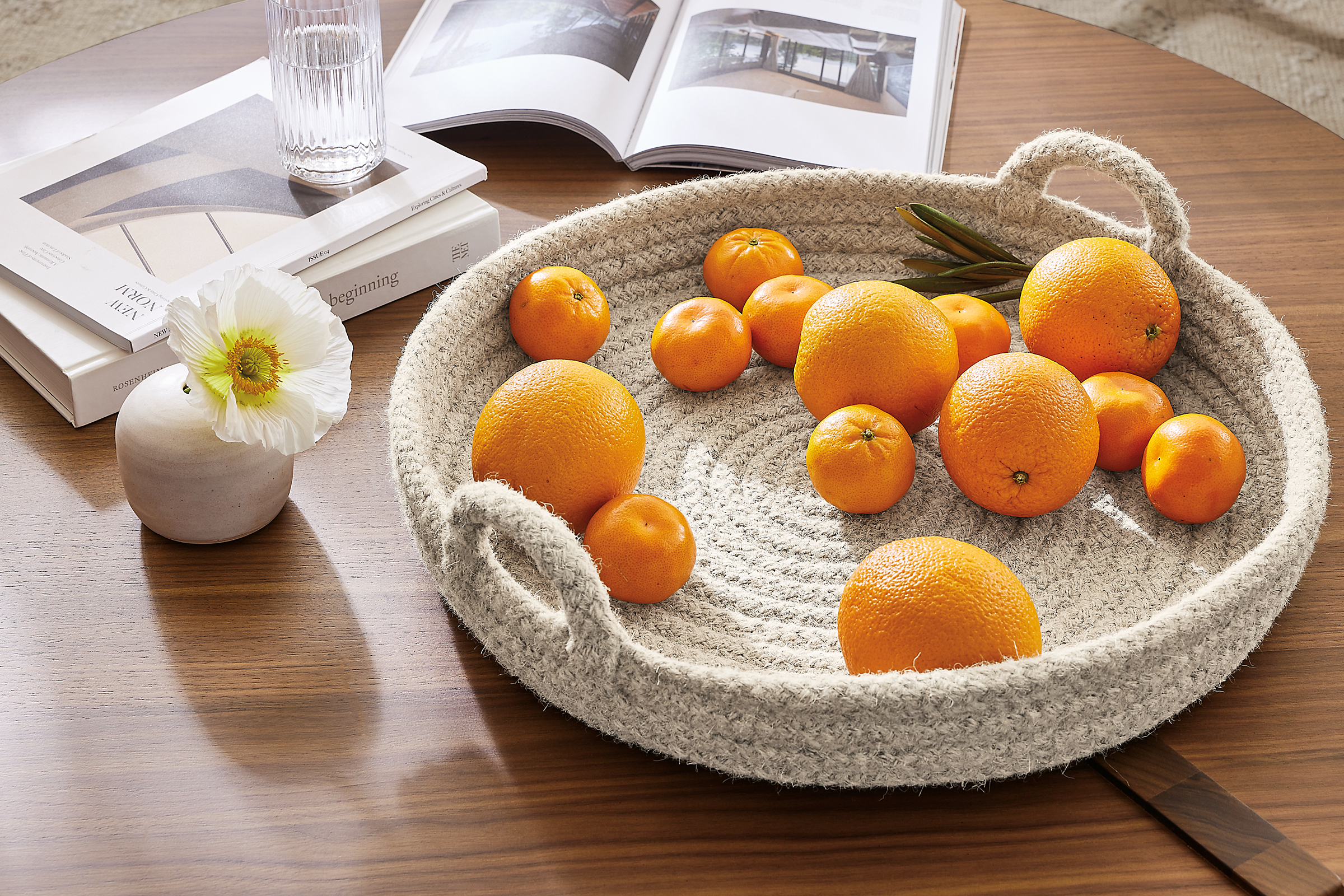Detail of Keegan wool tray with oranges in it on coffee table.