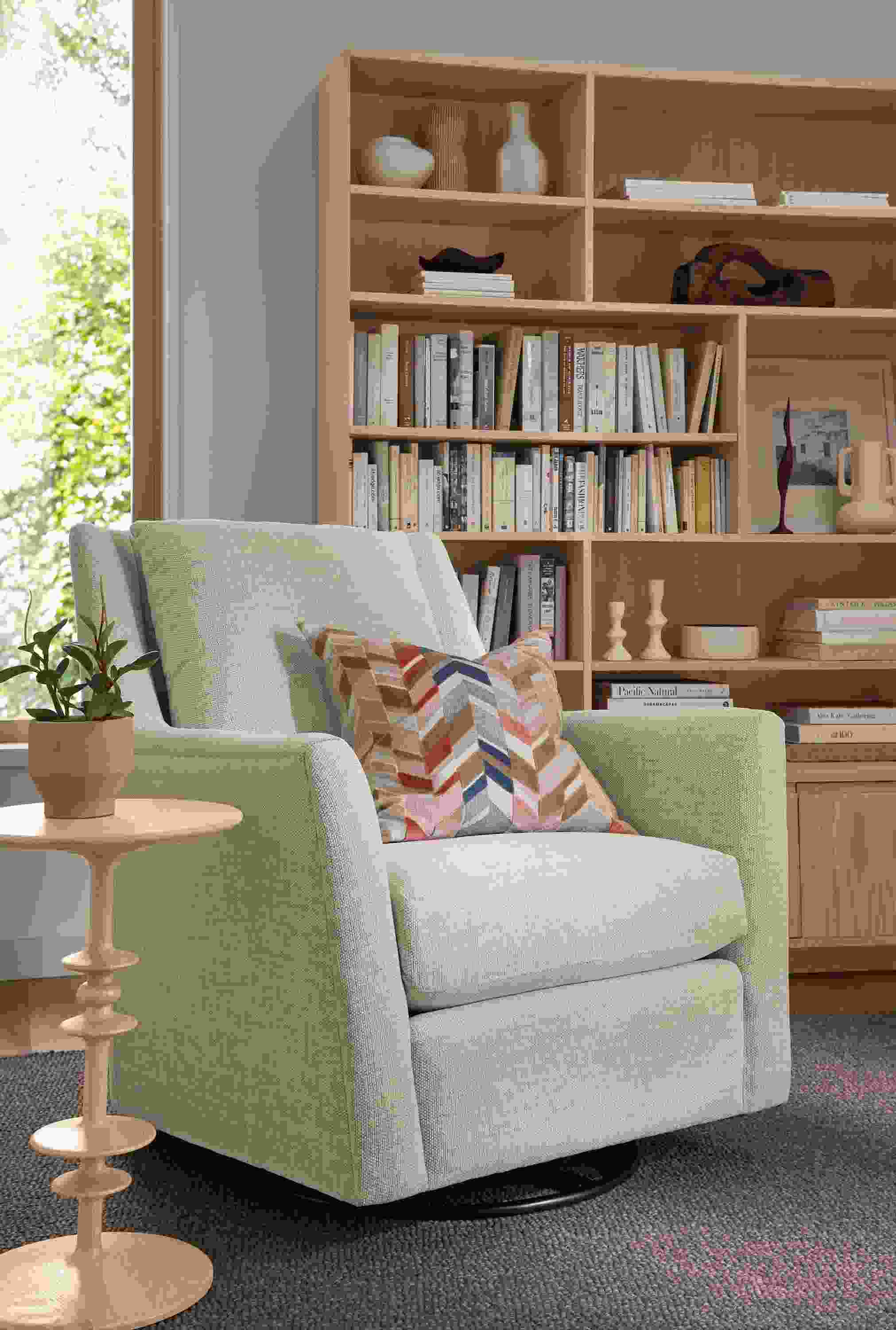 Living room with Kennedy swivel glider in Olmstead Natural and Parks round end table in salt on red oak.