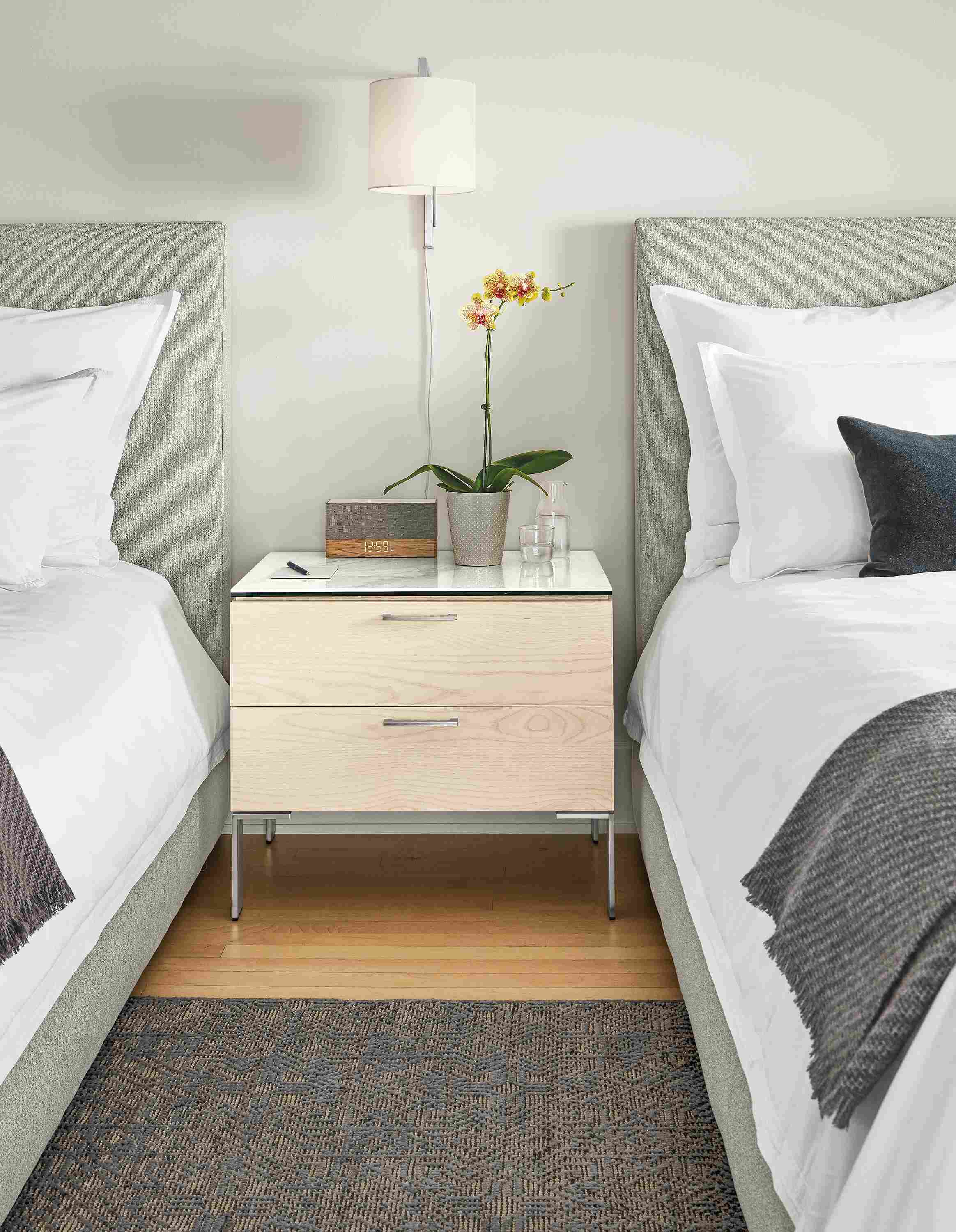 Detail of Kenwood nightstand with ceramic top in hotel setting.