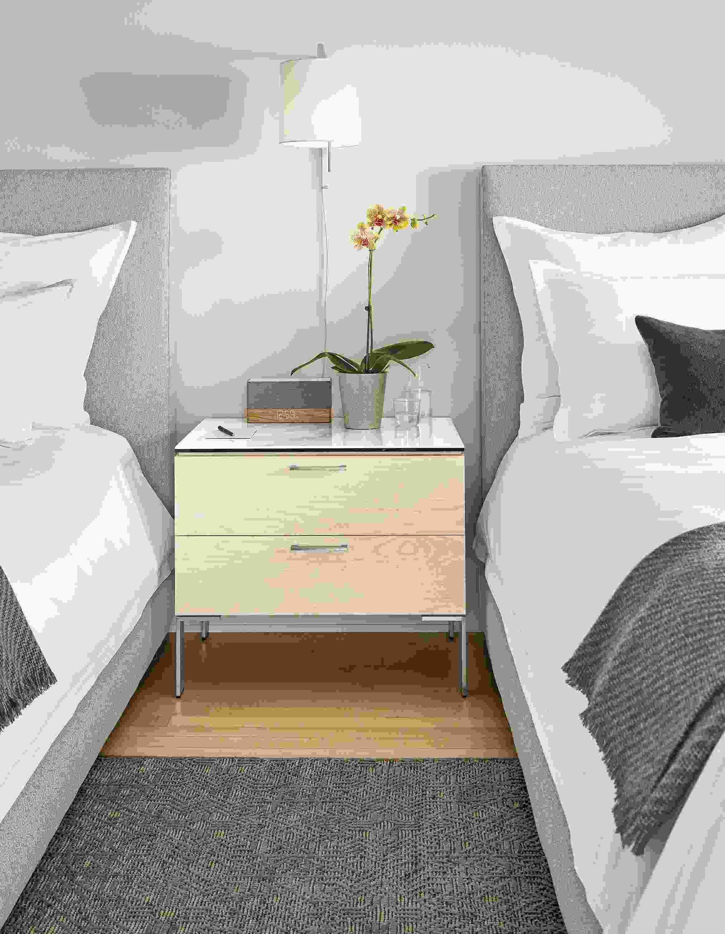 Detail of Kenwood nightstand with ceramic top in hotel setting.