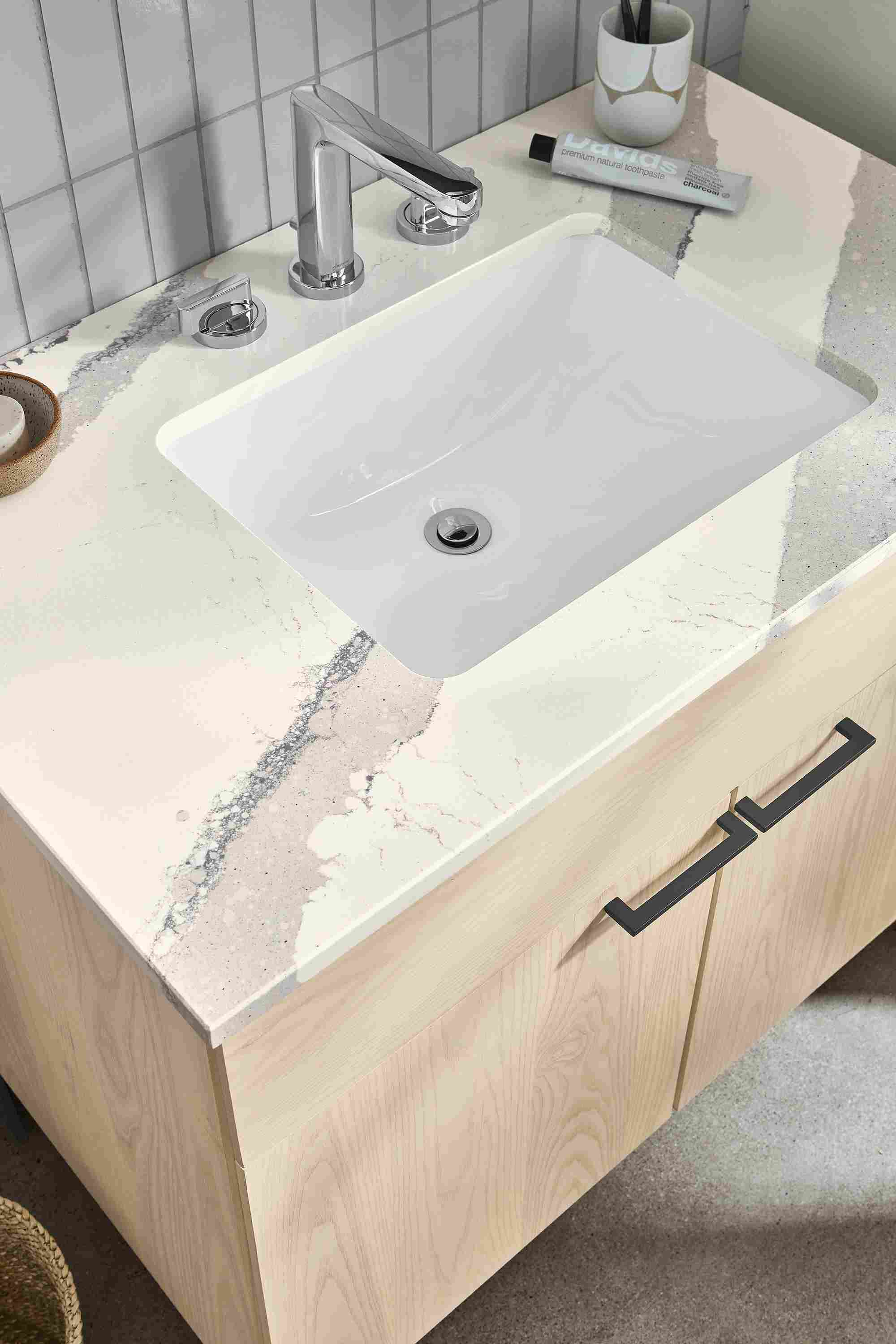 close-up of kenwood vanity in sand stain with cambria quartz top.