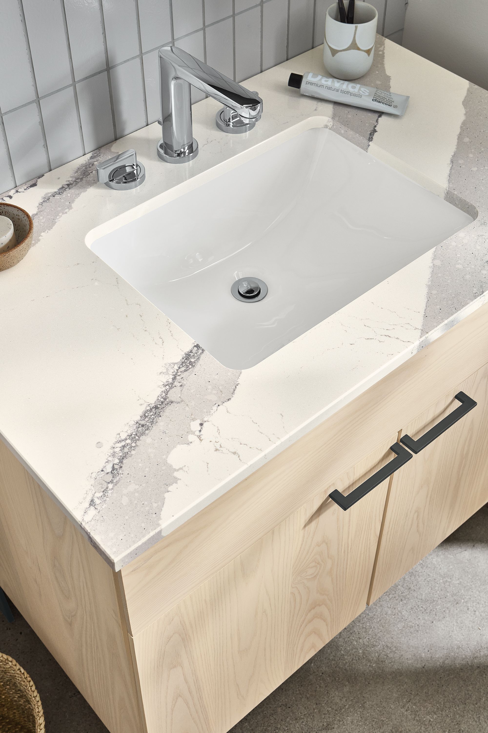 close-up of kenwood vanity in sand stain with cambria quartz top.