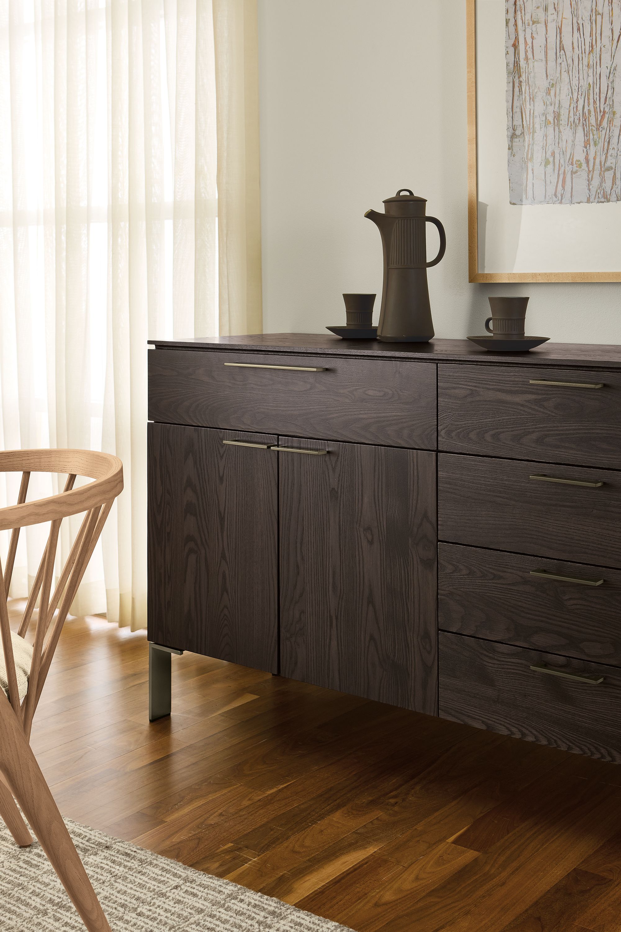 Dining room with Kenwood 84-wide storage cabinet in charcoal on ash with mineral hardware and nera rug in taupe.