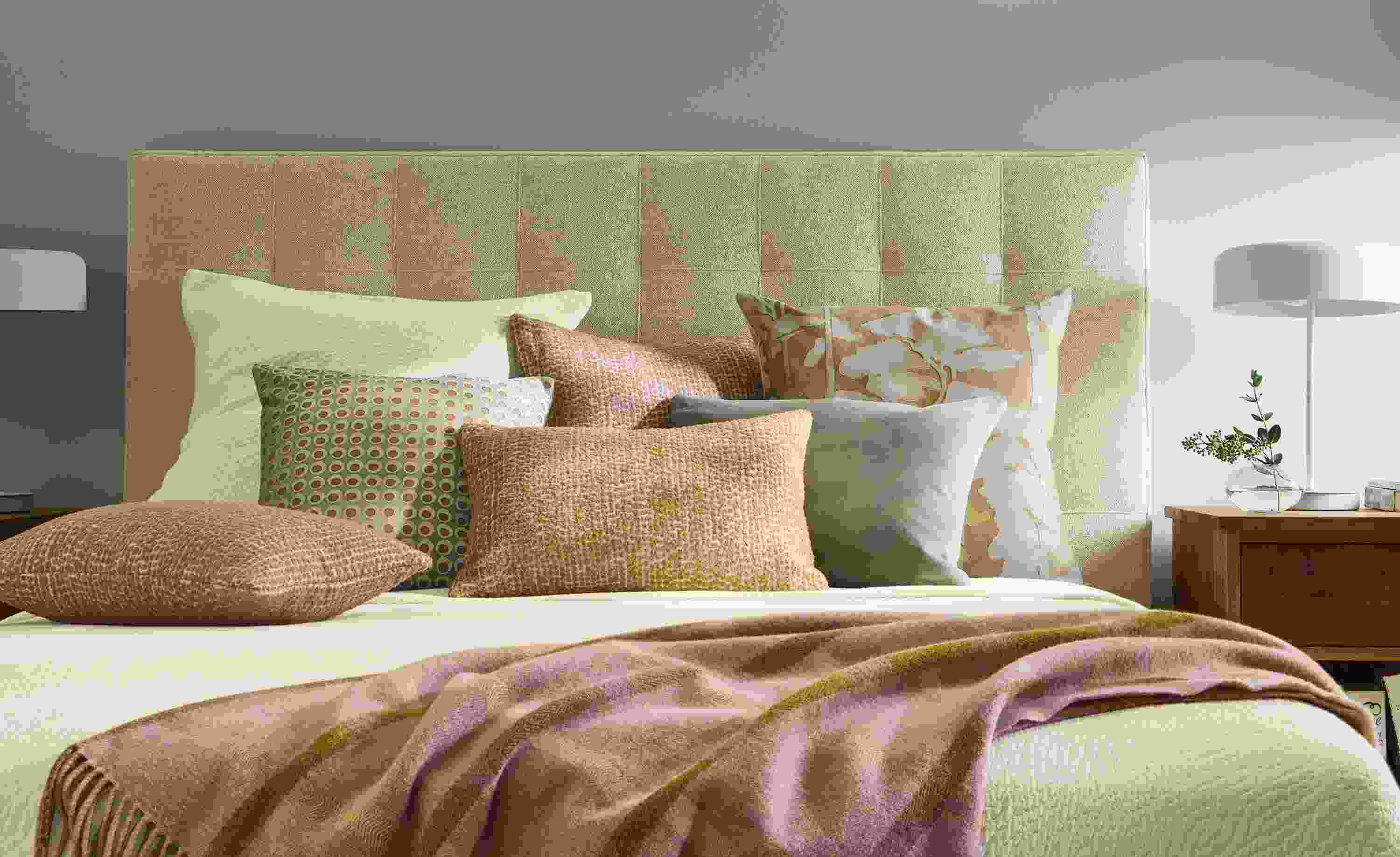 Bedroom showing pillow group including Dot, Koko, Velvet and Woodland pillows on an Avery bed.